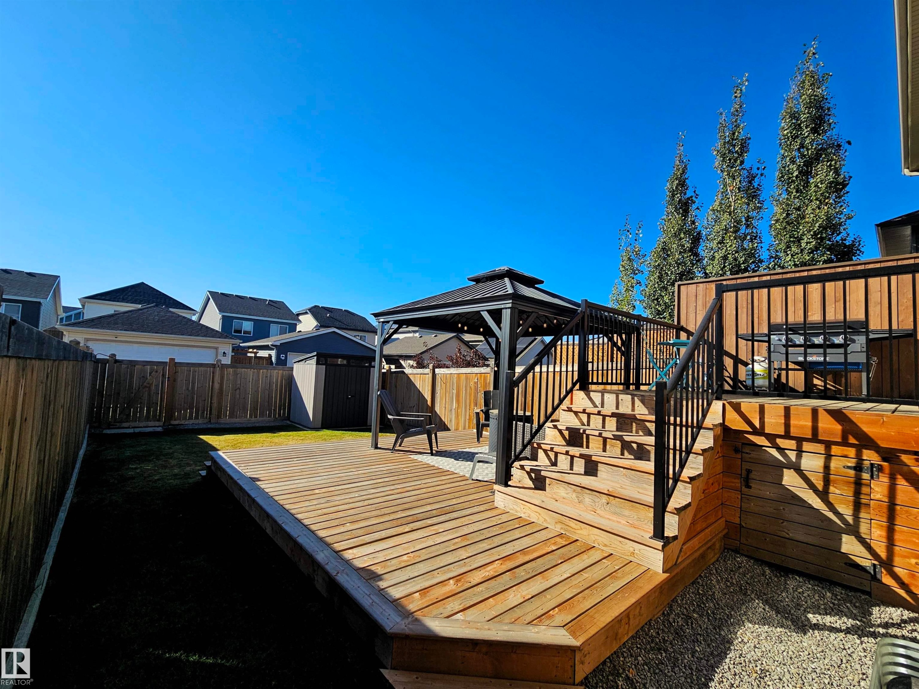 The property features an extensive backyard with a wooden deck, a gazebo, and a storage shed - 6888 Evans Wynd, Edmonton, AB - Outdoor