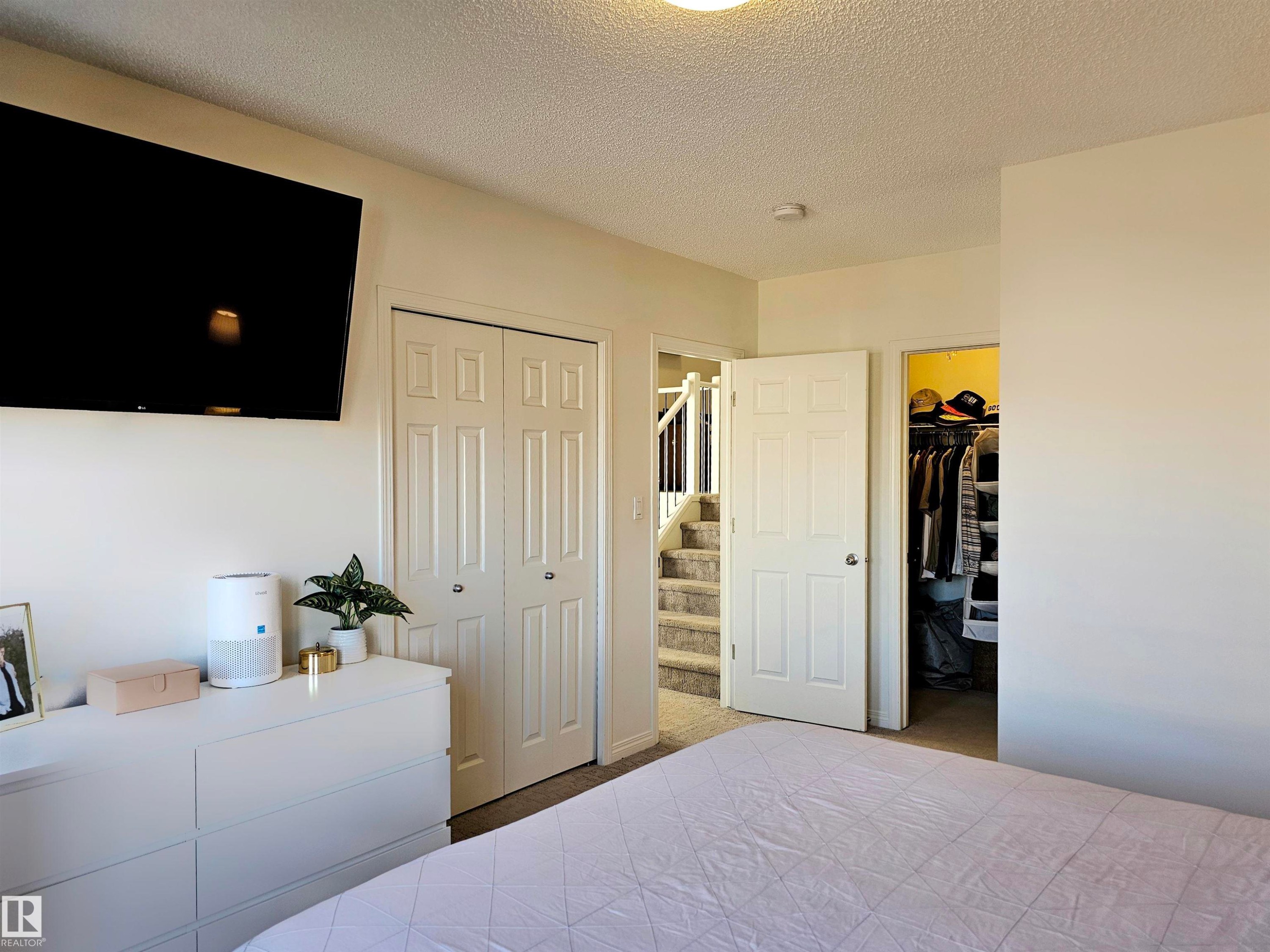 The room features light-colored walls and a textured ceiling - 6888 Evans Wynd, Edmonton, AB - Indoor Photo Showing Bedroom