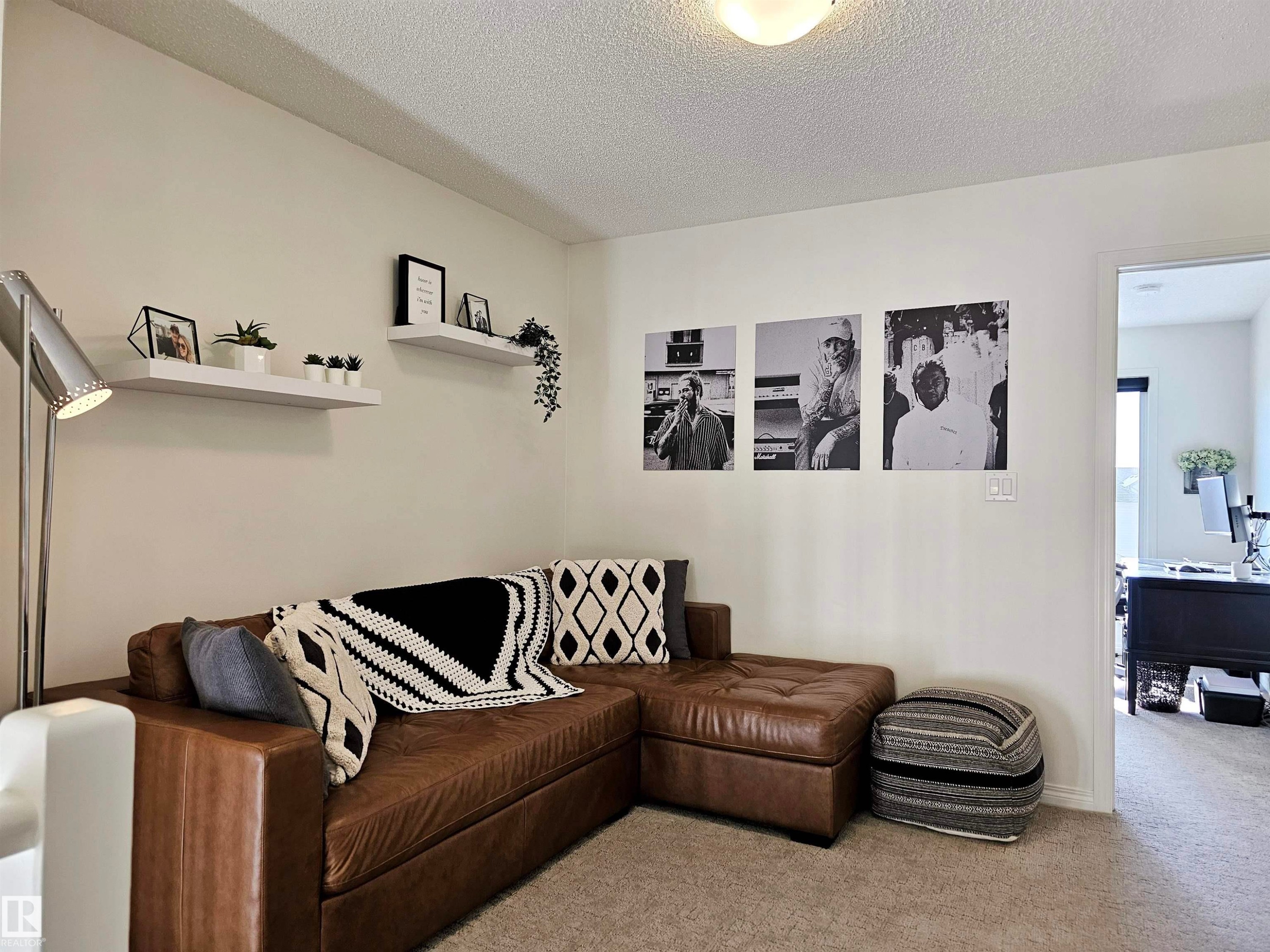 This inviting space features light-colored walls and carpeted flooring - 6888 Evans Wynd, Edmonton, AB - Indoor