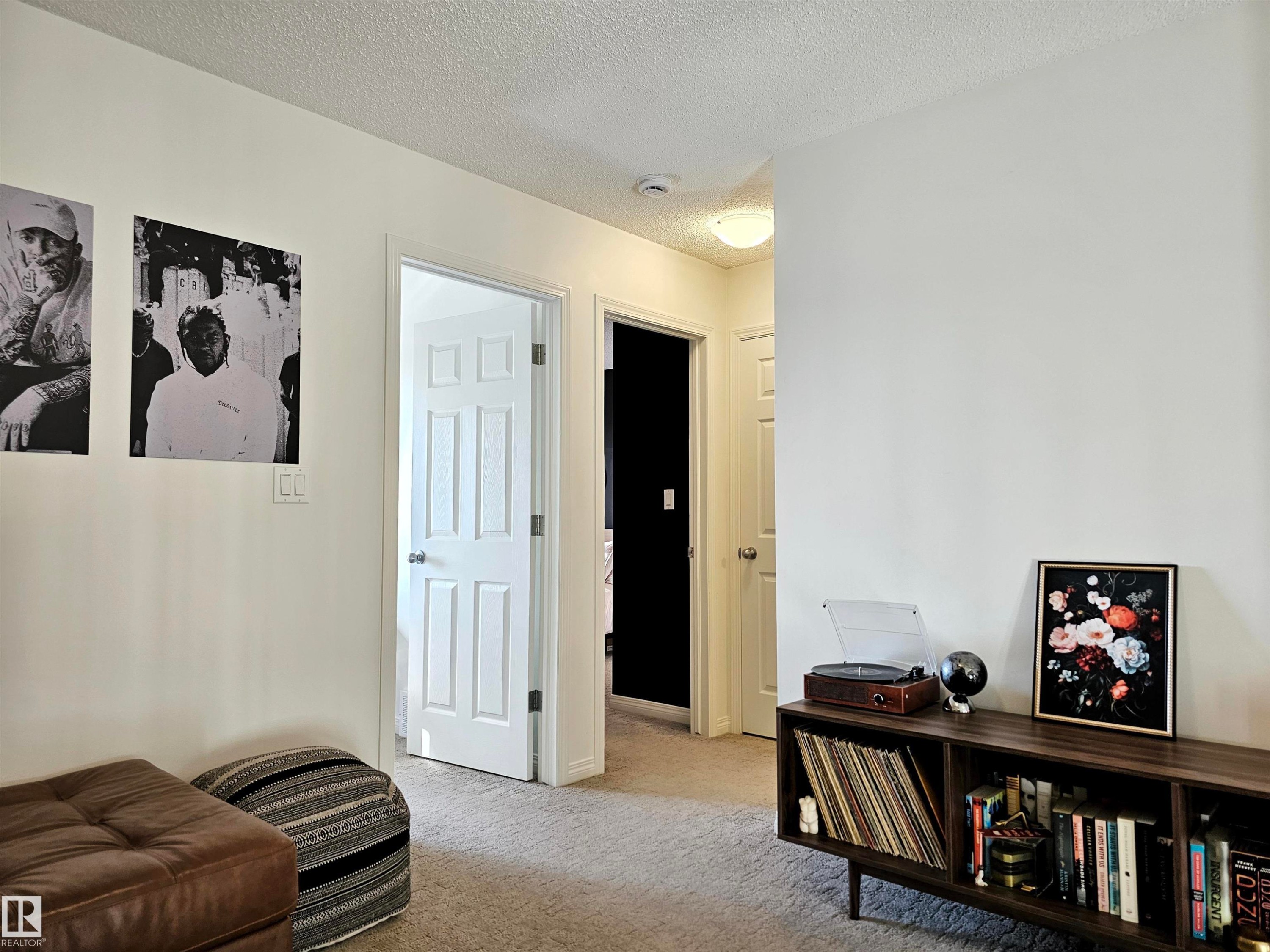 The interior offers neutral-toned walls, carpeted flooring, and white trim - 6888 Evans Wynd, Edmonton, AB - Indoor Photo Showing Other Room