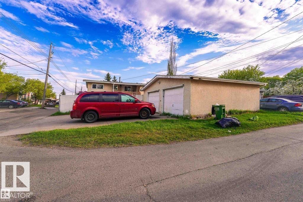 The property features a detached garage with two garage doors and a paved driveway - 12708 133A Avenue, Edmonton, AB - Outdoor