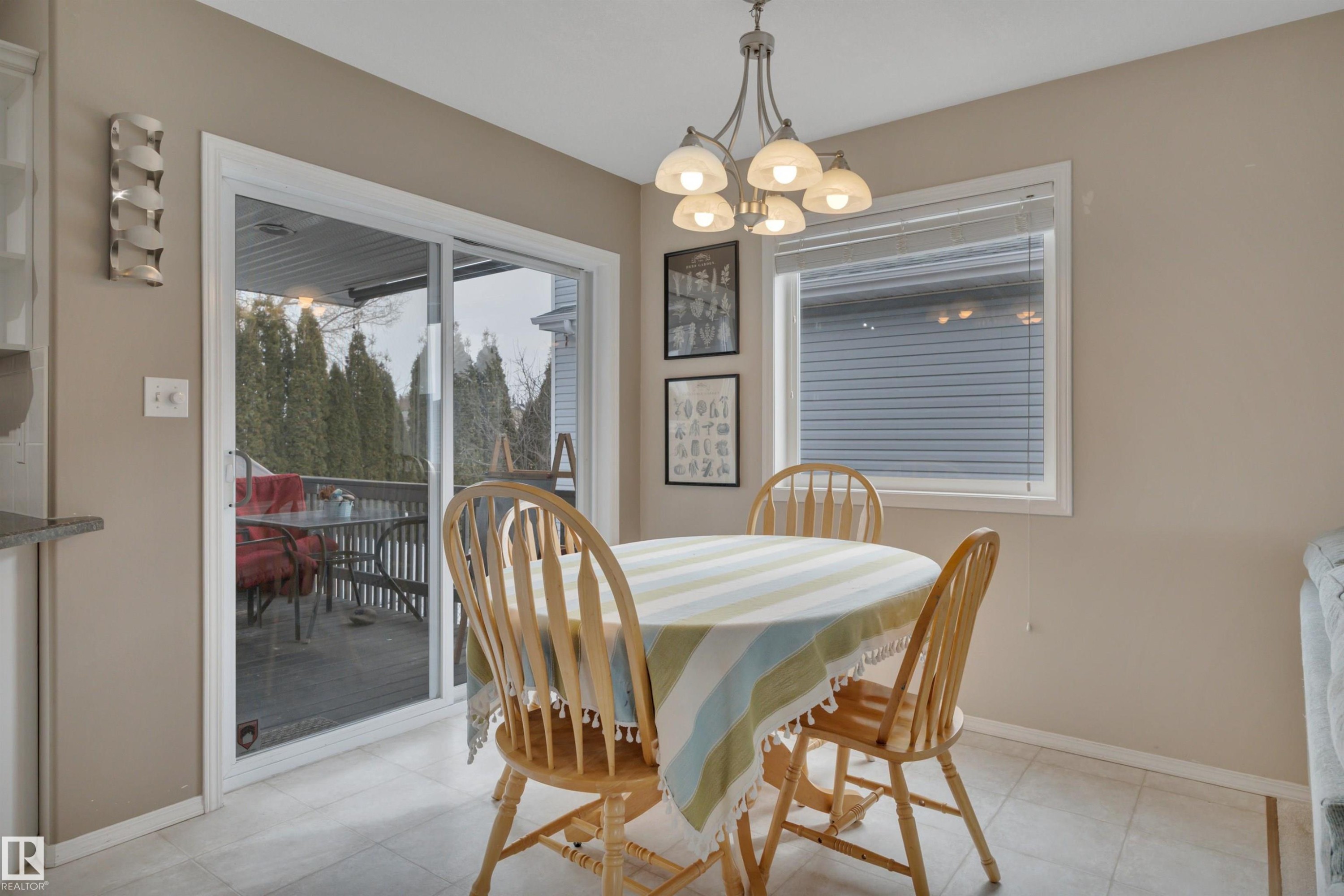 This dining area features a hanging light fixture and tiled flooring - 5 Parkview Crescent, Calmar, AB - Indoor Photo Showing Dining Room