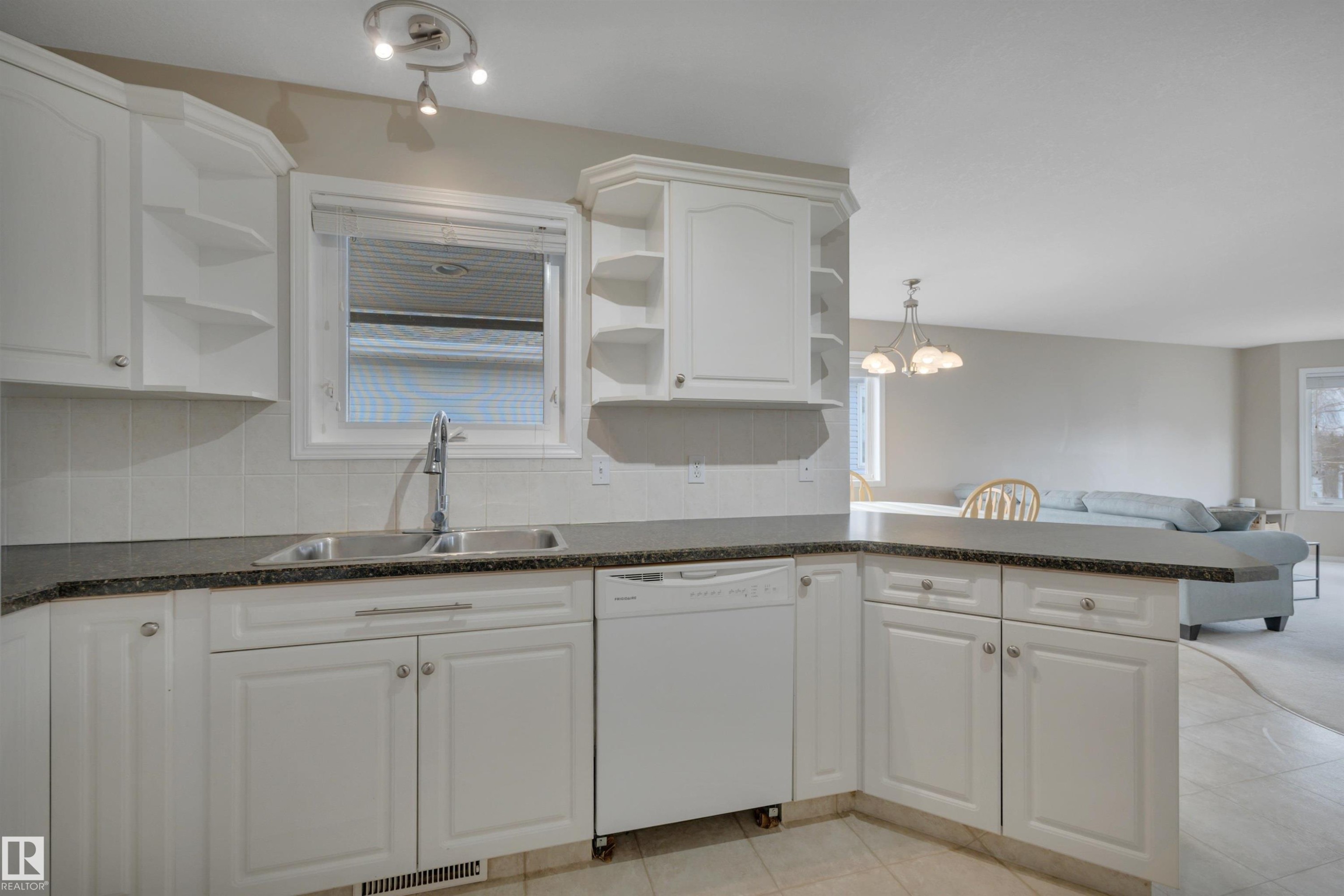 Kitchen featuring white cabinetry, a double basin sink, and a dishwasher, with granite-style countertops - 5 Parkview Crescent, Calmar, AB - Indoor Photo Showing Kitchen With Double Sink