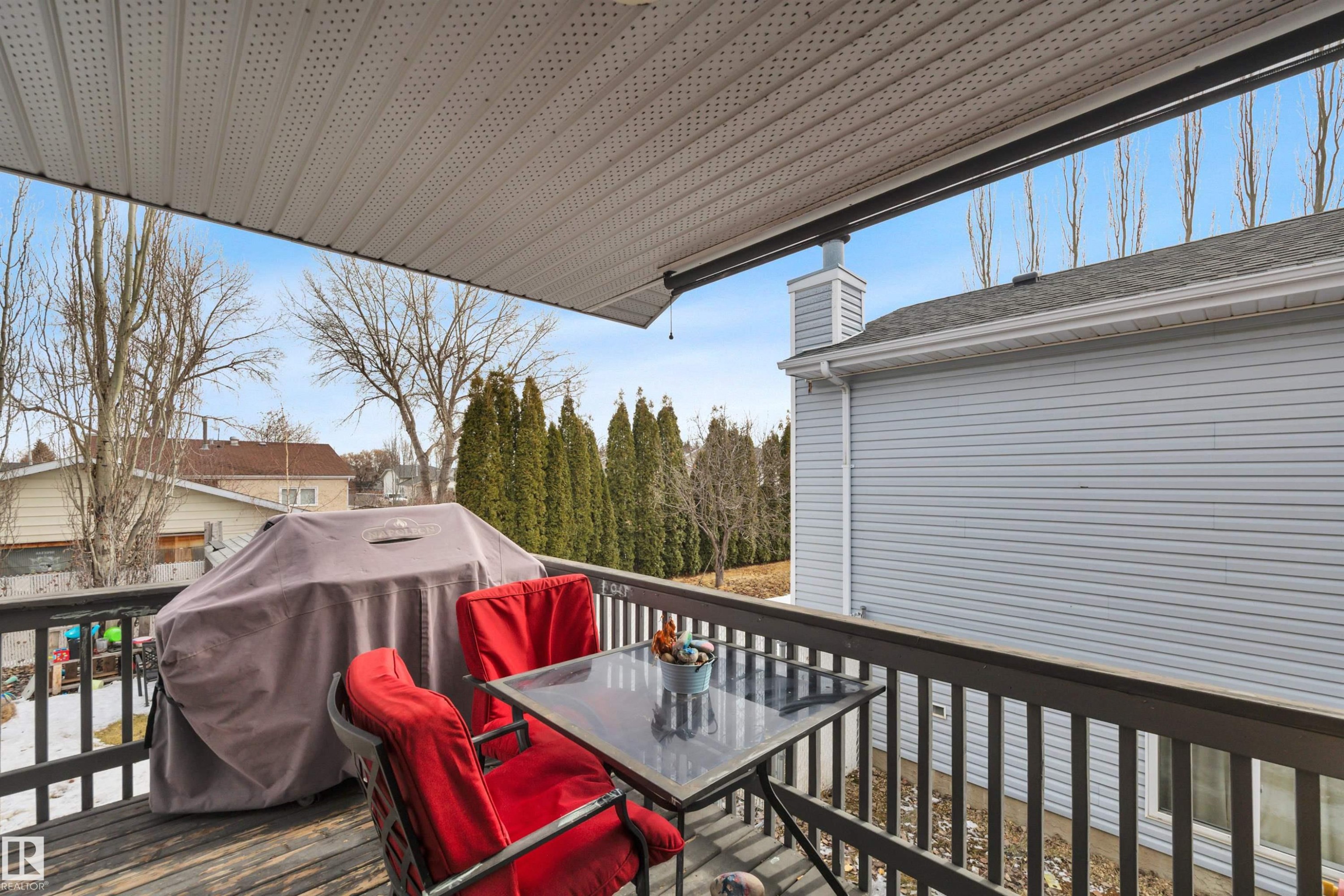 The property features a wooden deck with a dark railing, offering an outdoor living space - 5 Parkview Crescent, Calmar, AB - Outdoor With Deck Patio Veranda With Exterior