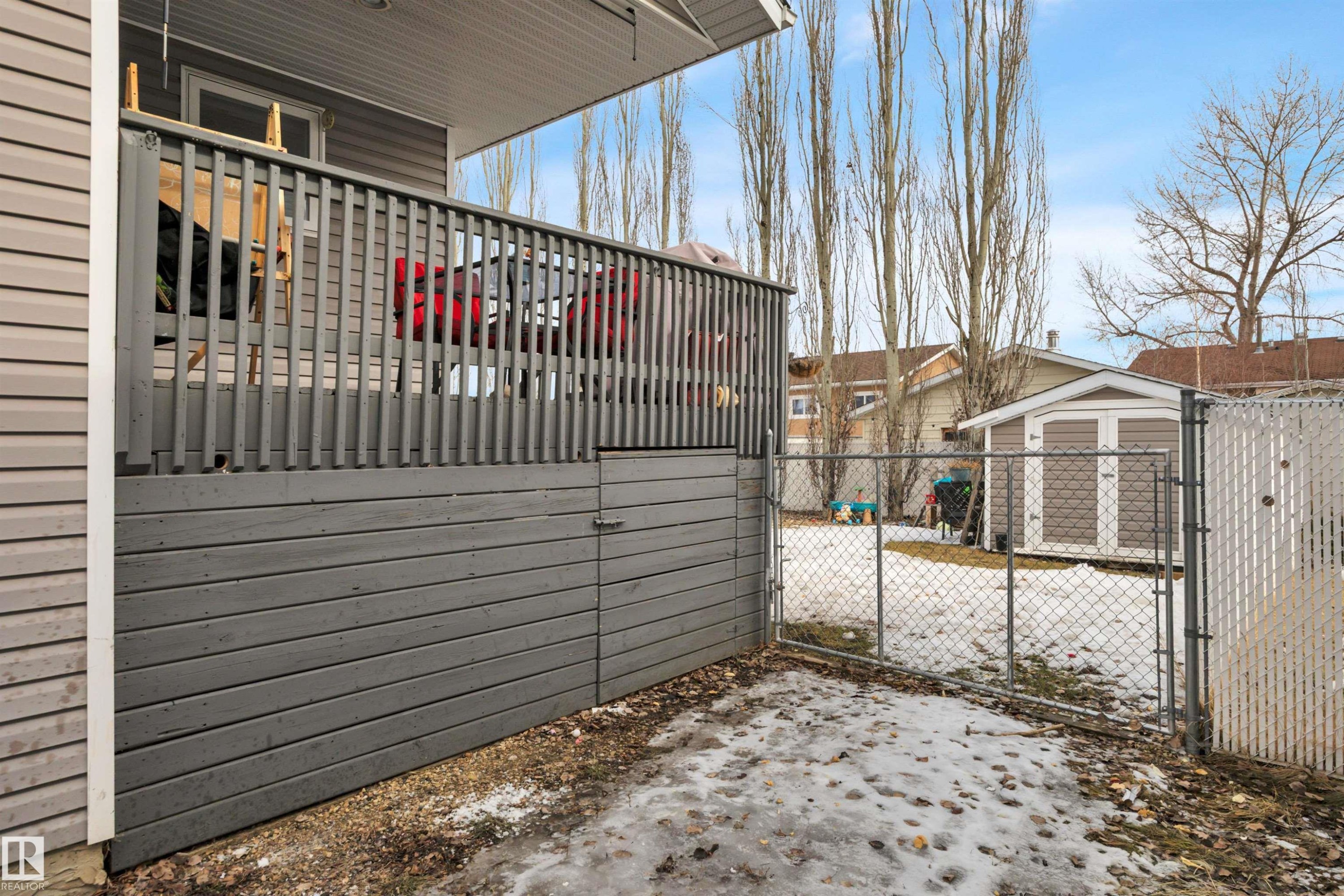The property features a fenced yard, a storage shed, and an elevated deck with privacy lattice - 5 Parkview Crescent, Calmar, AB - Outdoor With Exterior
