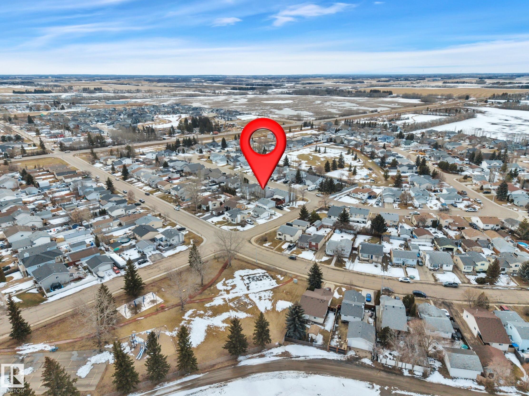 This aerial view highlights the property's location within a residential neighborhood featuring numerous detached homes - 5 Parkview Crescent, Calmar, AB - Outdoor With View
