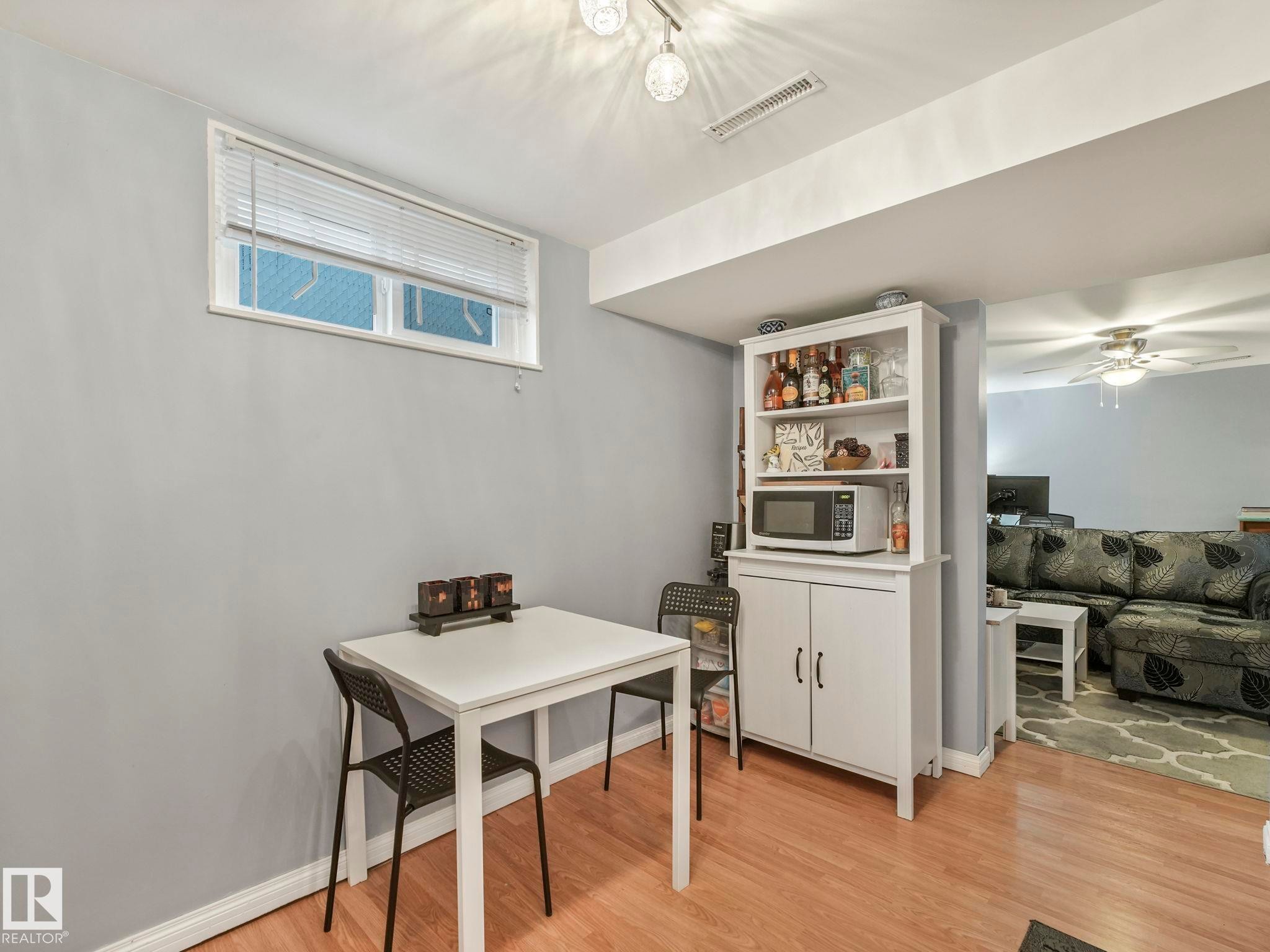 This area features wood flooring, a window with blinds, and recessed lighting - 12141 96 Street, Edmonton, AB - Indoor