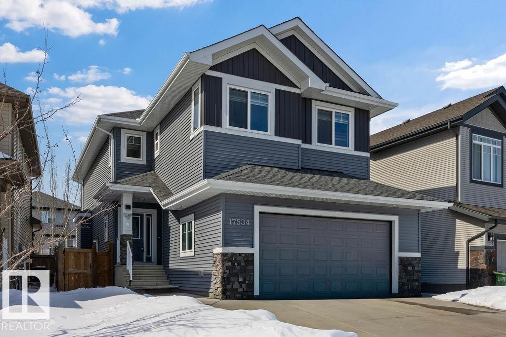 The property features a two-story exterior with multi-toned grey siding and white trim - 17534 60A Street, Edmonton, AB - Outdoor With Facade