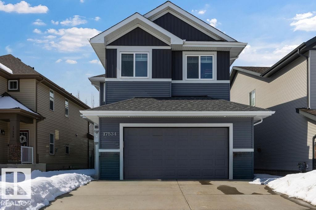 The property features a two-story exterior with multi-toned siding, a two-car garage, and a concrete driveway - 17534 60A Street, Edmonton, AB - Outdoor