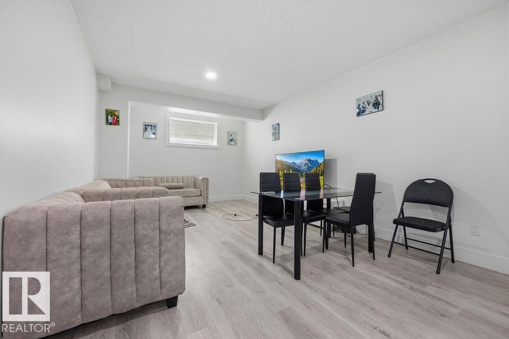 The property features light-toned flooring and white walls throughout the living area - 17534 60A Street, Edmonton, AB - Indoor