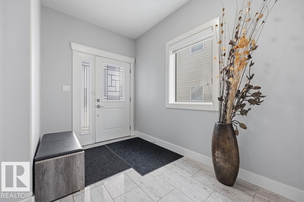 The property features a bright entrance with a white front door that includes decorative glass panels and a sidelight - 17534 60A Street, Edmonton, AB - Indoor Photo Showing Other Room