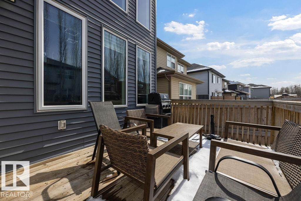 The property features a wood deck and dark siding - 17534 60A Street, Edmonton, AB - Outdoor With Deck Patio Veranda With Exterior
