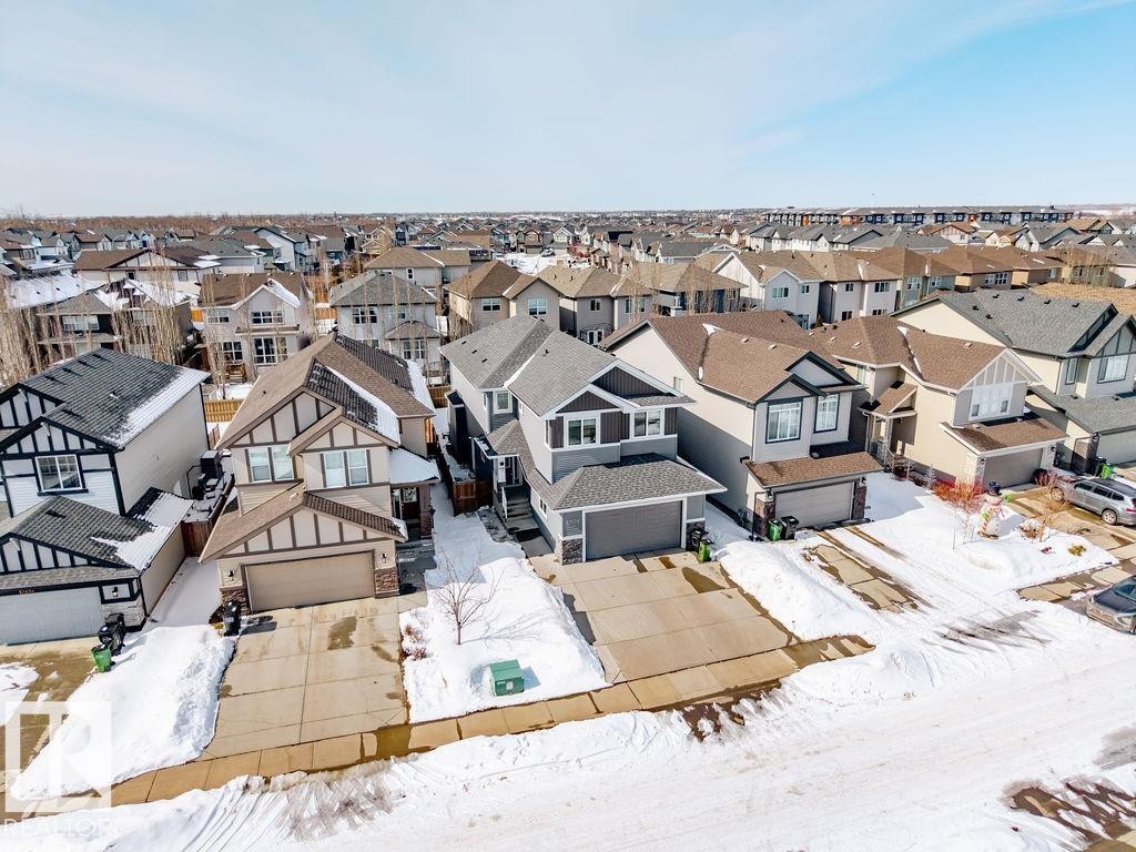 This property features a two-story design with an attached garage and a concrete driveway - 17534 60A Street, Edmonton, AB - Outdoor With Facade