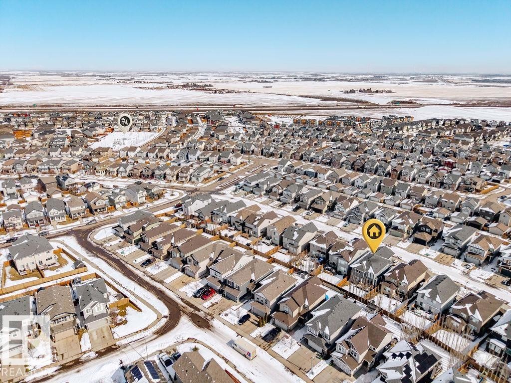 Aerial view of a residential community featuring numerous houses with various roof styles and colors, surrounded by snow-dusted ground and roads - 17534 60A Street, Edmonton, AB - Outdoor With View