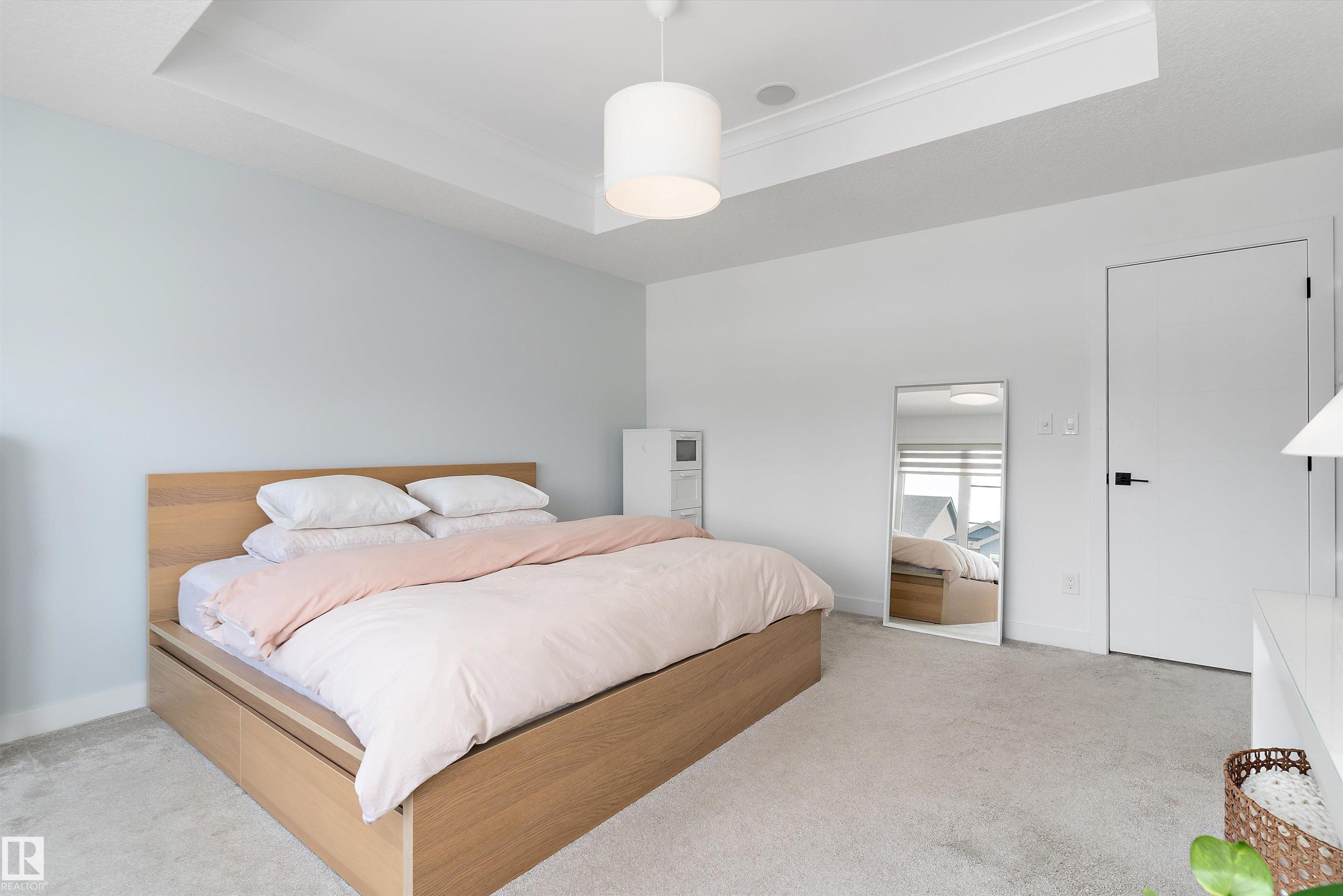 This room features light-colored walls and a tray ceiling with recessed lighting - 1305 Enright Landing, Edmonton, AB - Indoor Photo Showing Bedroom