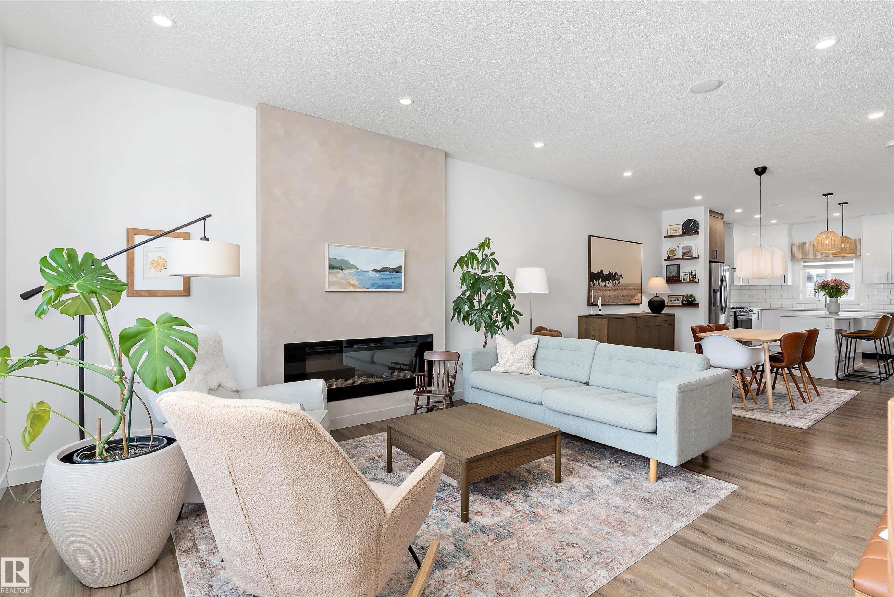This inviting living space features wood-style flooring, a modern fireplace, and recessed lighting - 1305 Enright Landing, Edmonton, AB - Indoor Photo Showing Living Room With Fireplace