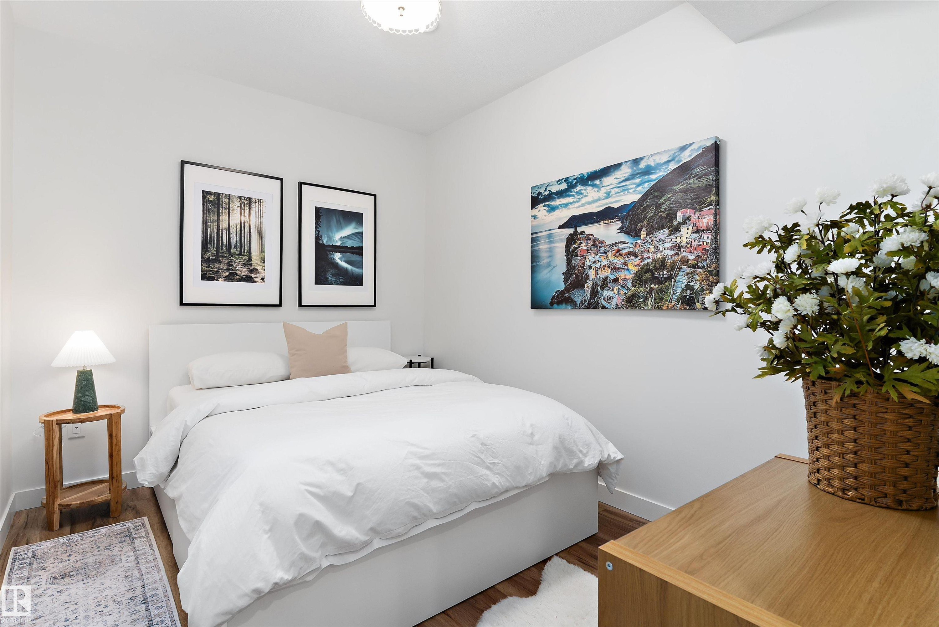 This room features light wood flooring, bright white walls, and a recessed ceiling light fixture - 1305 Enright Landing, Edmonton, AB - Indoor Photo Showing Bedroom