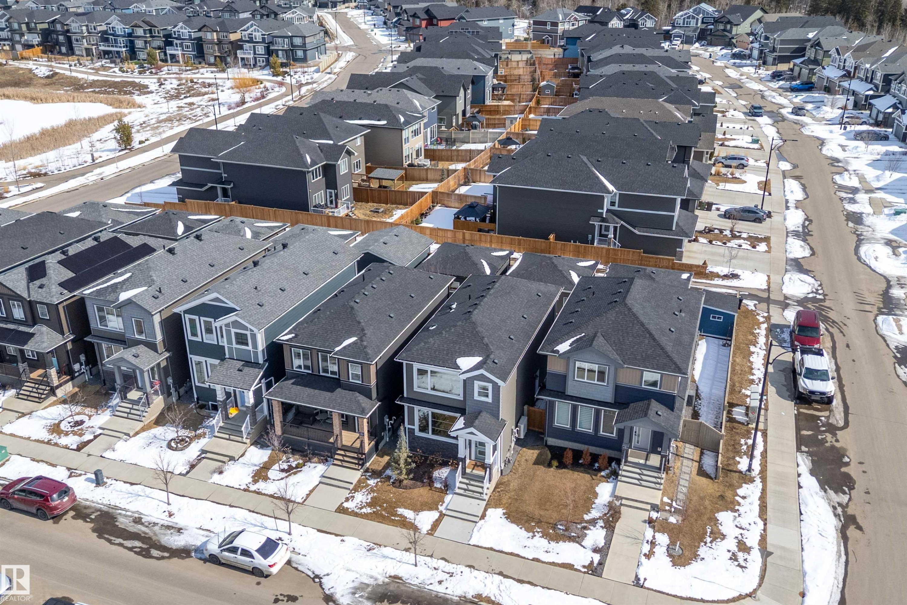 Aerial view of the residential property showcasing the roof, front yard, and driveway - 1305 Enright Landing, Edmonton, AB - Outdoor
