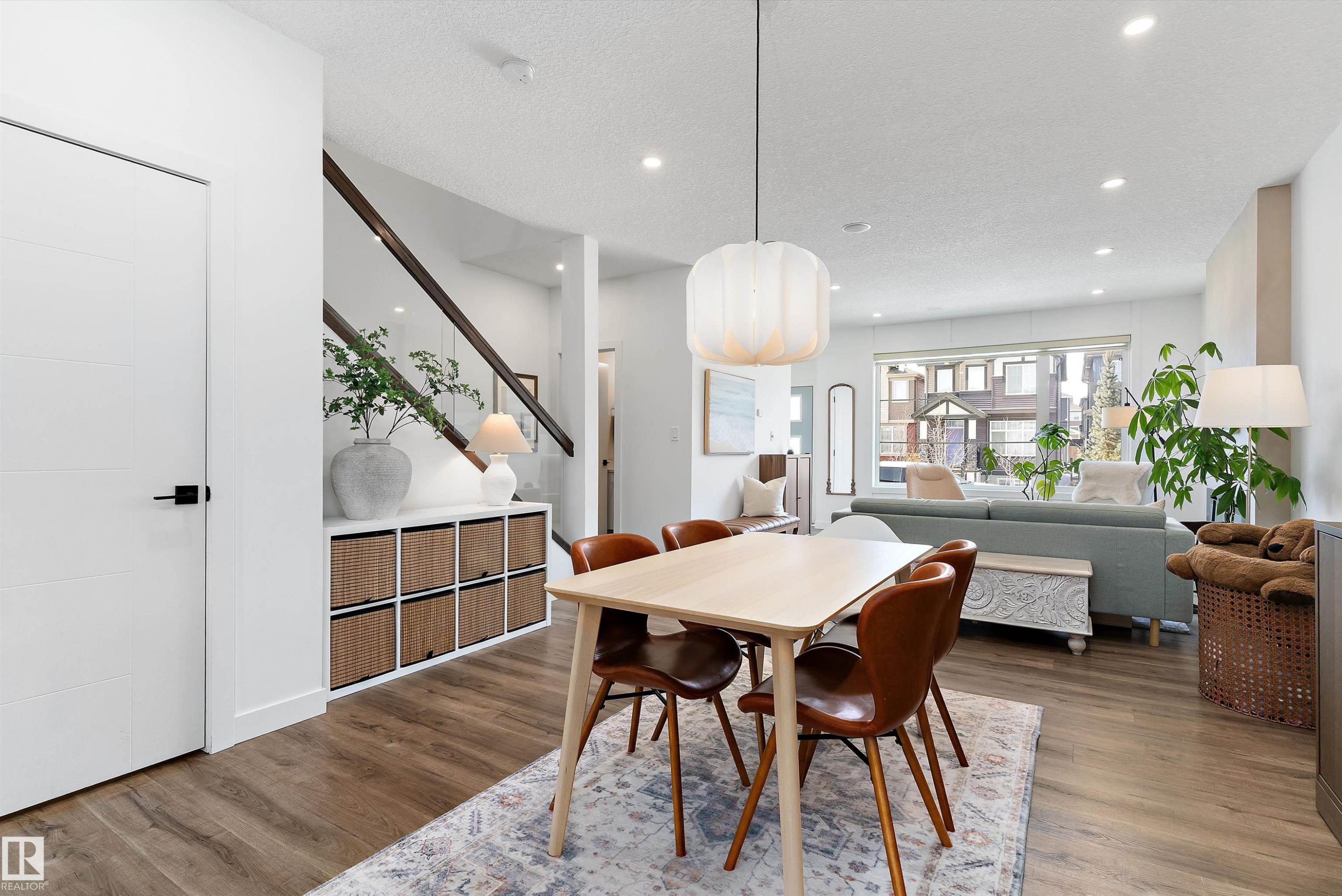 The property features an open-concept living area with hardwood flooring, recessed lighting, and a modern light fixture above the dining space - 1305 Enright Landing, Edmonton, AB - Indoor