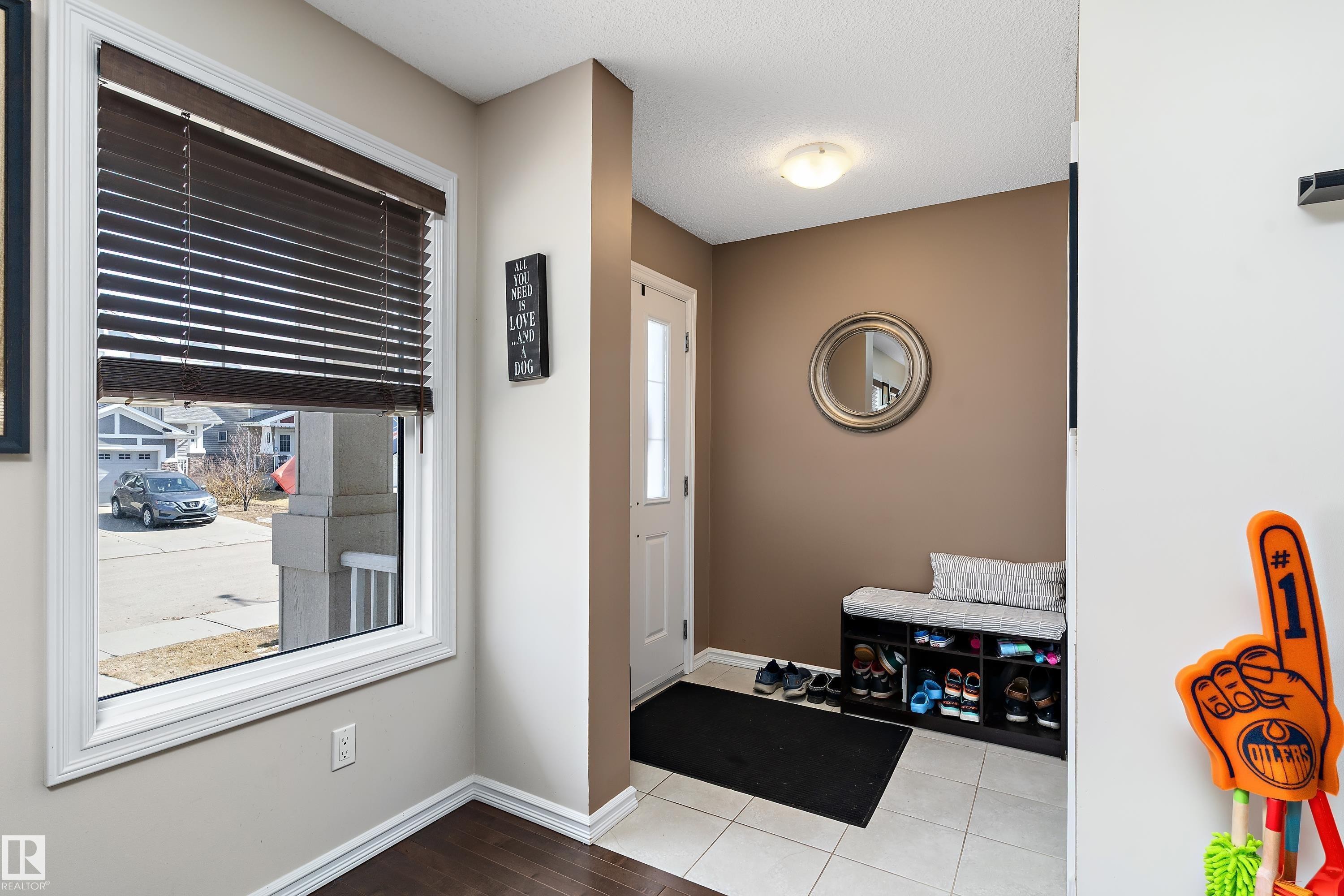 Entryway featuring a window with dark blinds, a white door, and tiled flooring - 6822 Cardinal Link, Edmonton, AB - Indoor Photo Showing Other Room