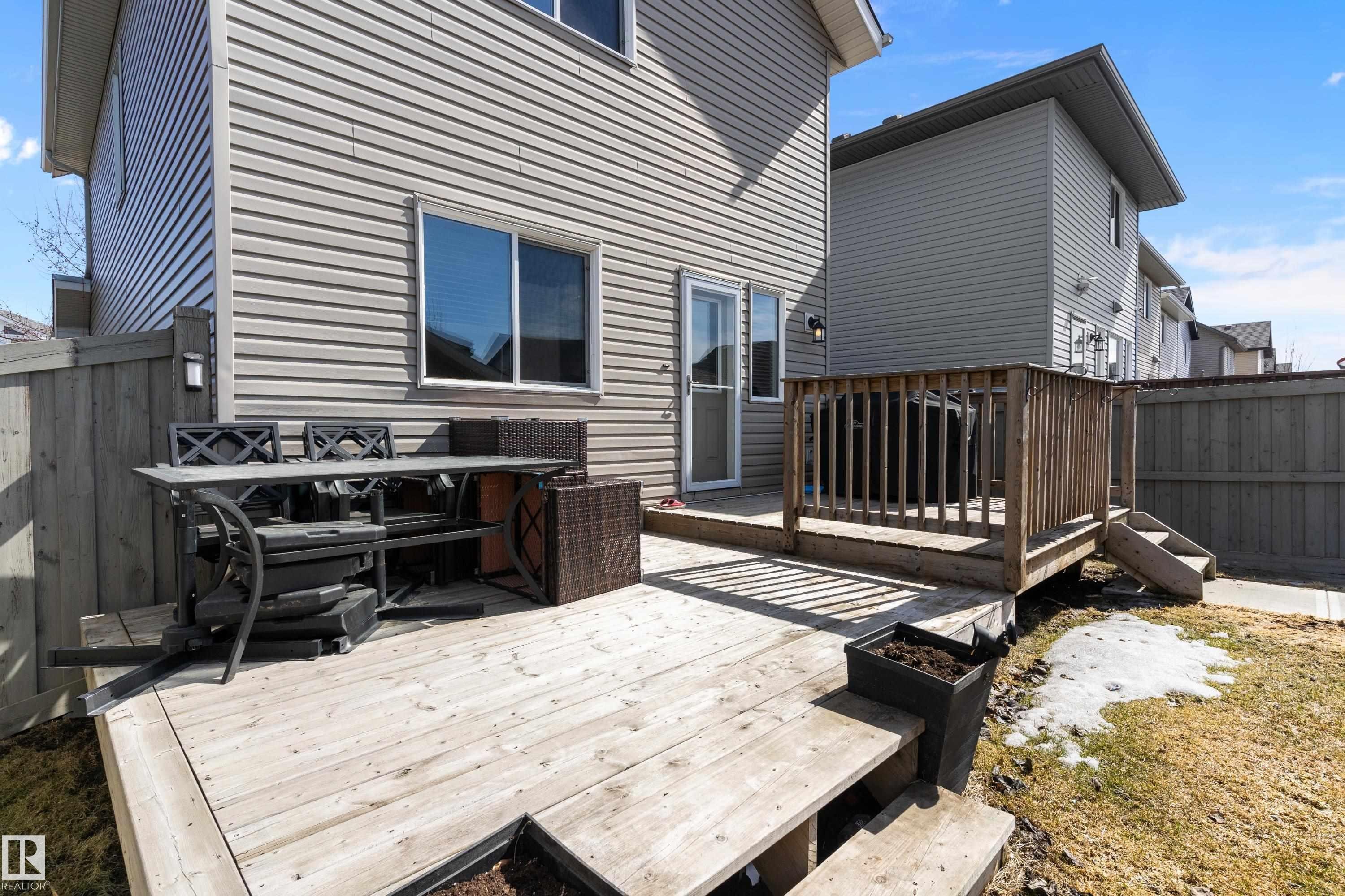 The property features a multi-level wooden deck, offering ample outdoor living space - 6822 Cardinal Link, Edmonton, AB - Outdoor With Deck Patio Veranda With Exterior