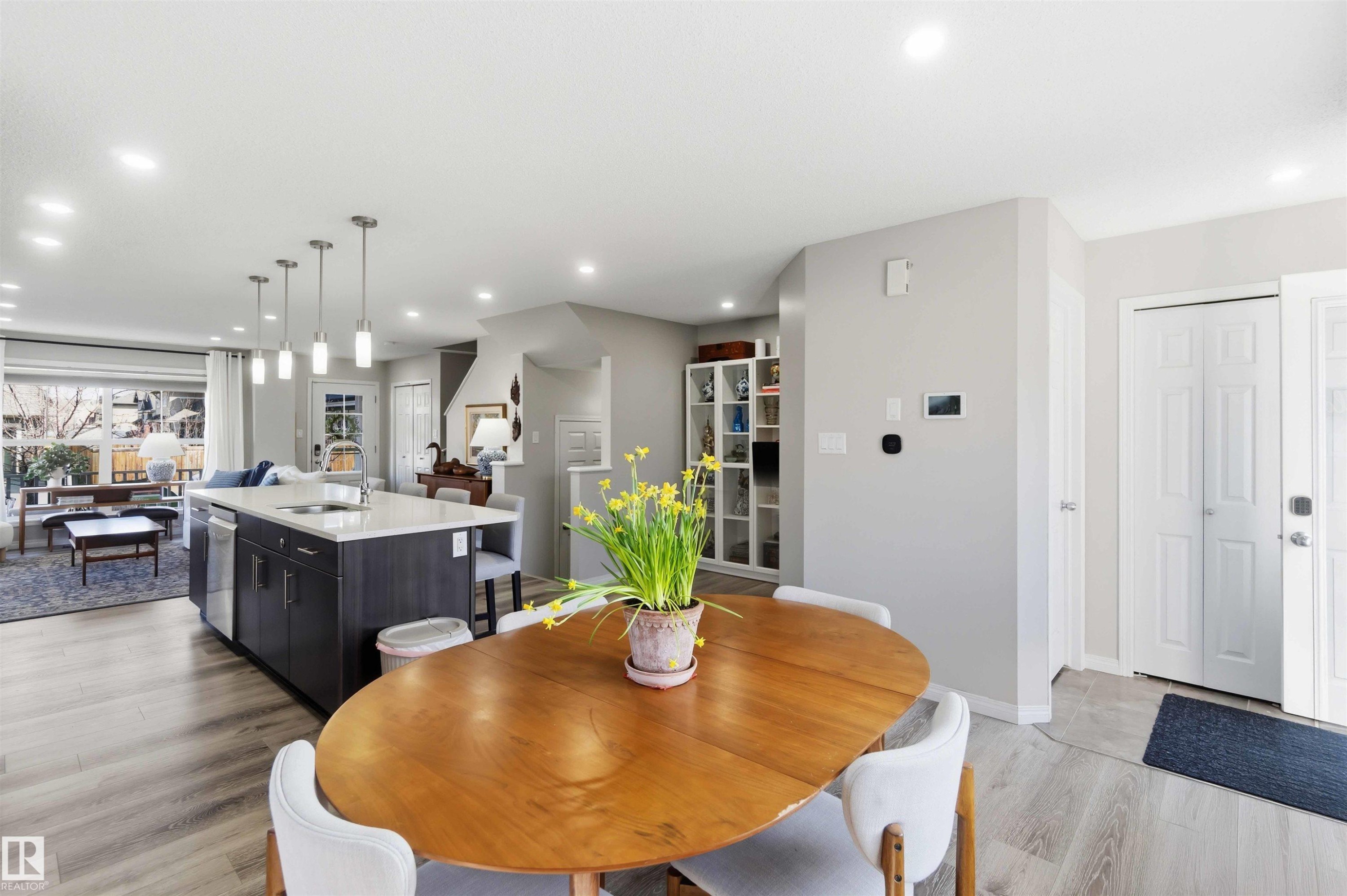 The property features an open-concept layout with light-colored flooring throughout - 4750 Crabapple Run, Edmonton, AB - Indoor Photo Showing Dining Room