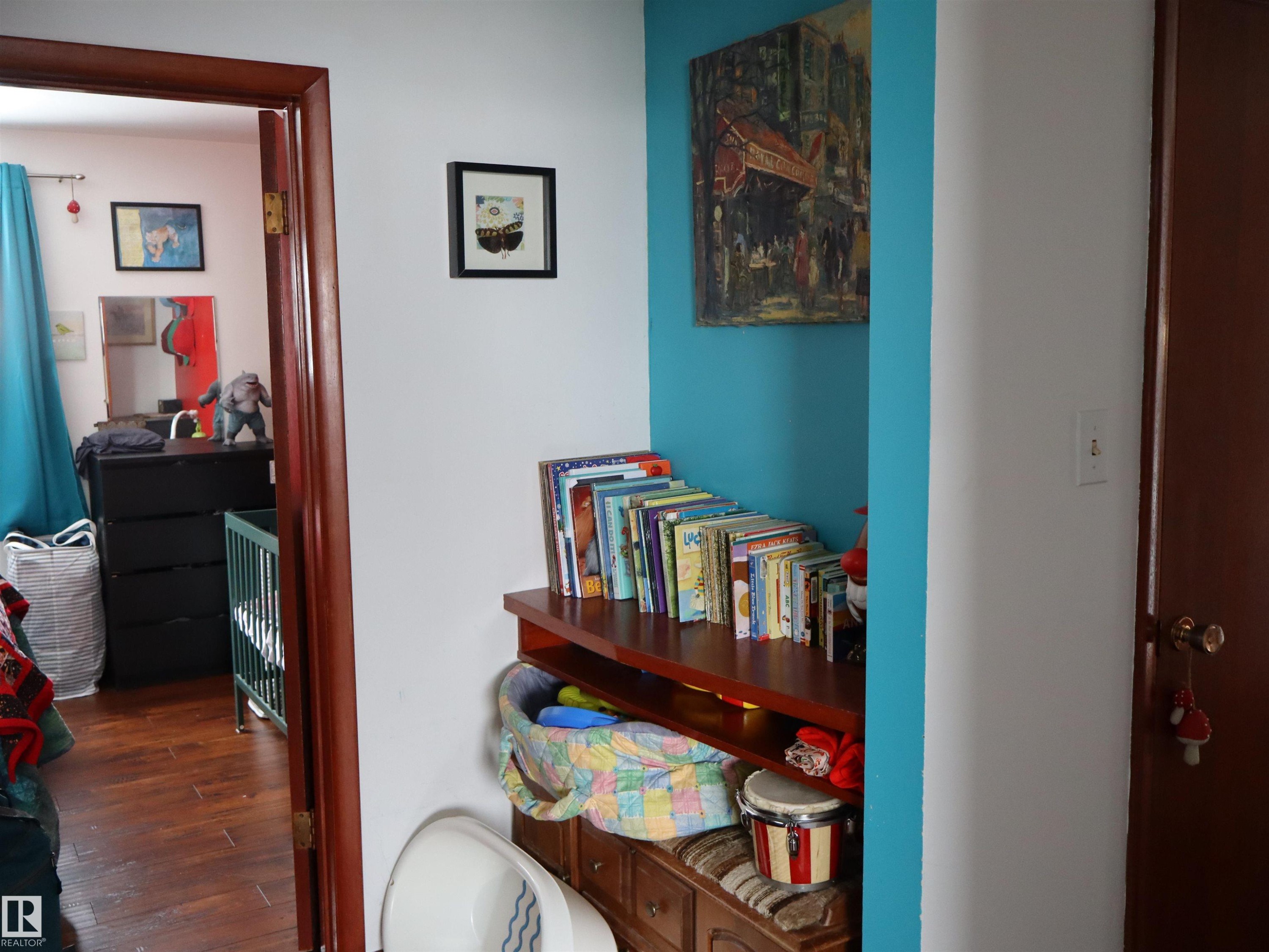 The property features hardwood style flooring in the room visible through the doorway - 4315 56 Avenue, Barrhead, AB - Indoor