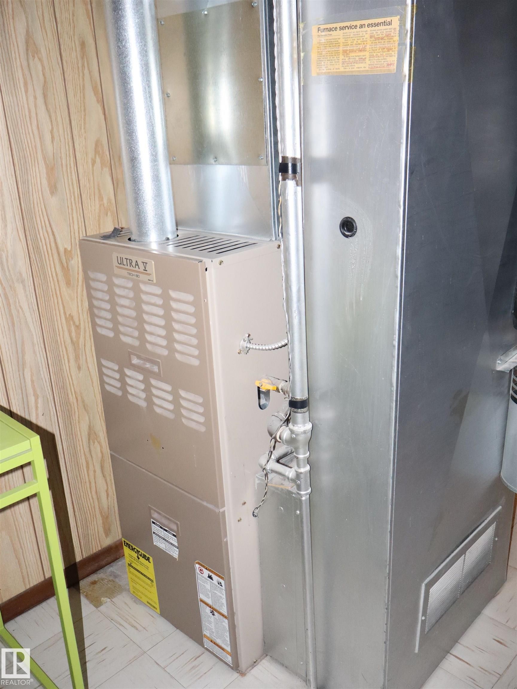 The property is equipped with a furnace system, visible with metal ductwork and piping - 4315 56 Avenue, Barrhead, AB - Indoor Photo Showing Basement