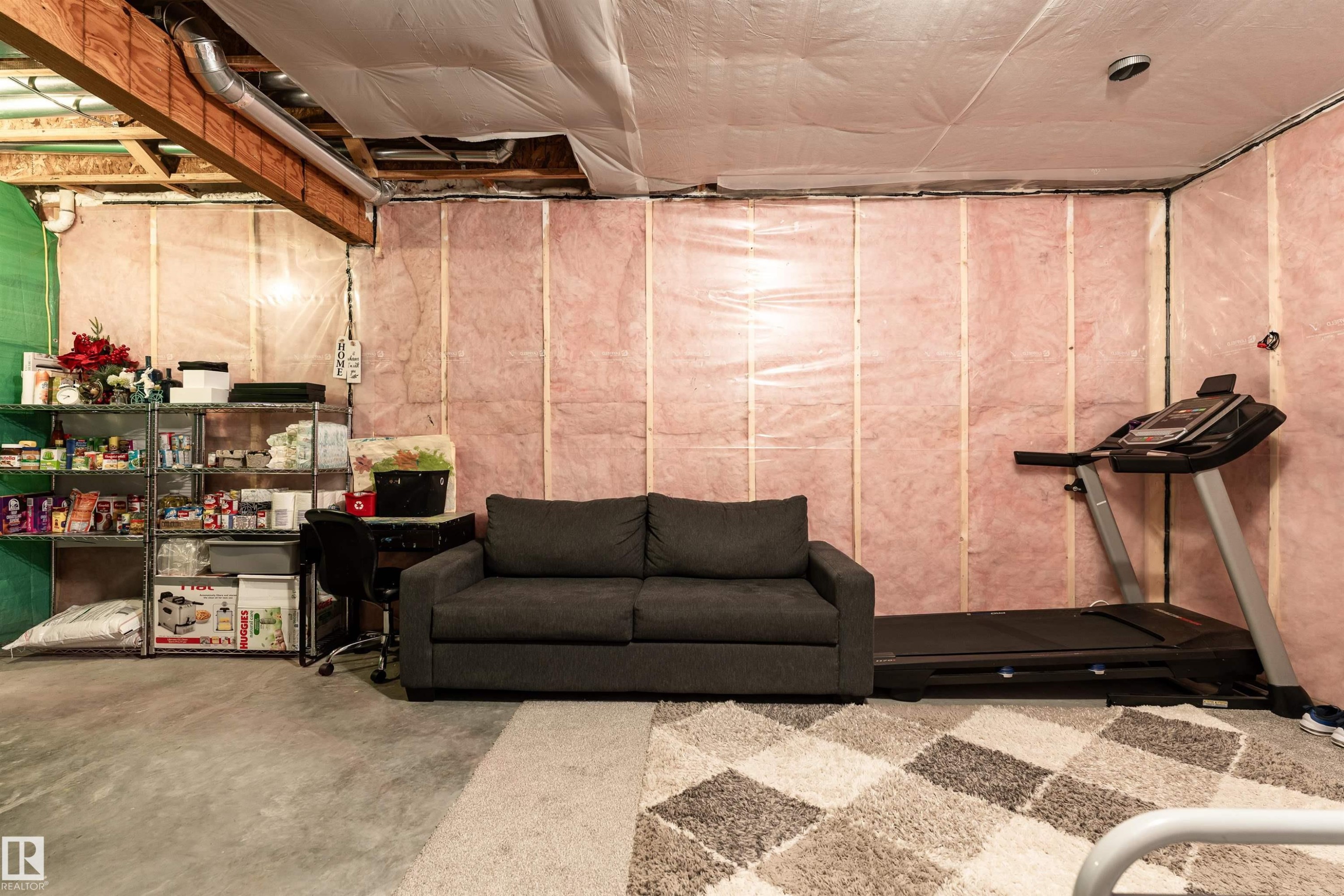 The property features an unfinished basement with exposed wooden joists and ductwork, providing potential for customization - 22742 95A Ave, Edmonton, AB - Indoor Photo Showing Basement