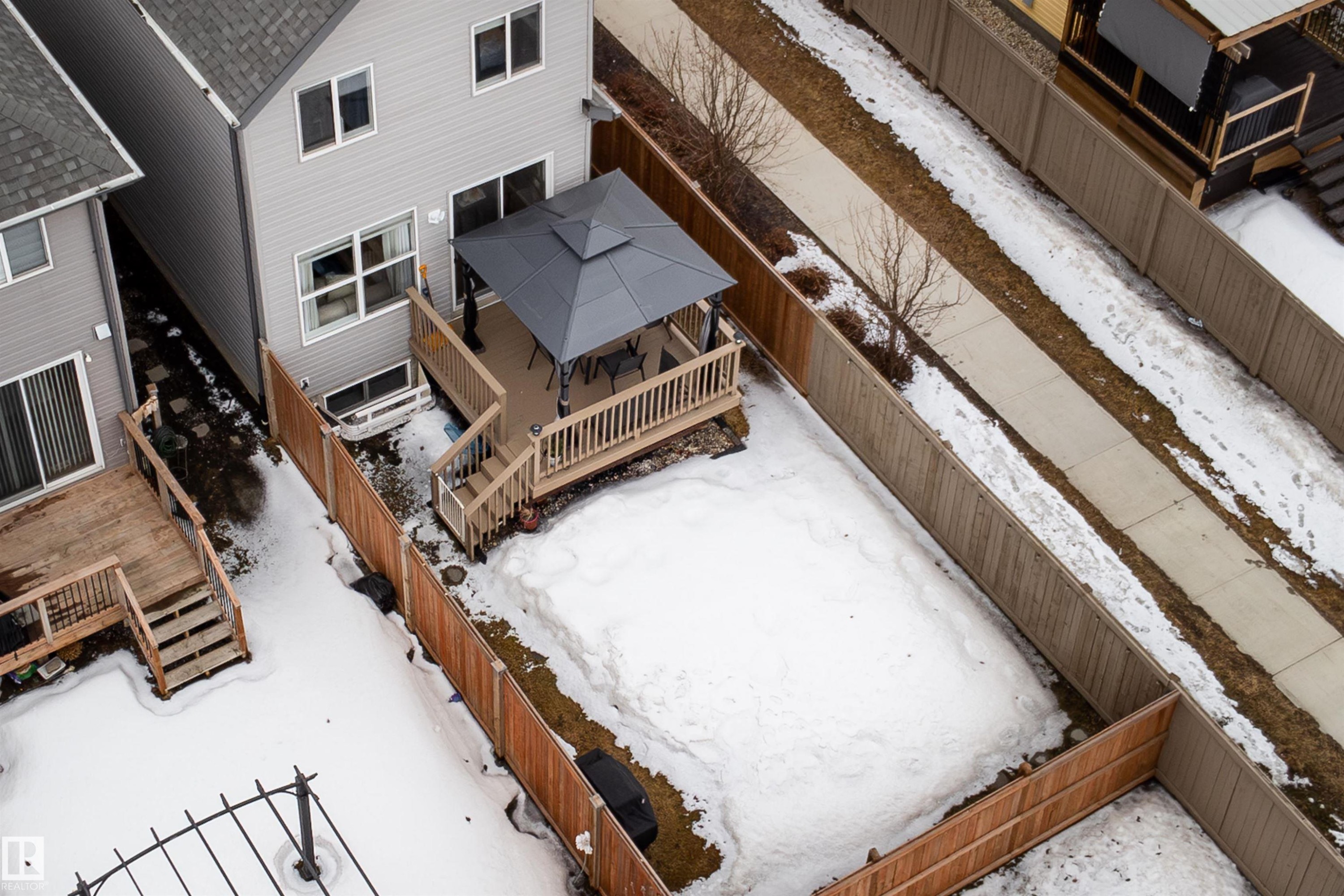 The property features a fenced yard, a wooden deck, and a gazebo - 22742 95A Ave, Edmonton, AB - Indoor Photo Showing Other Room