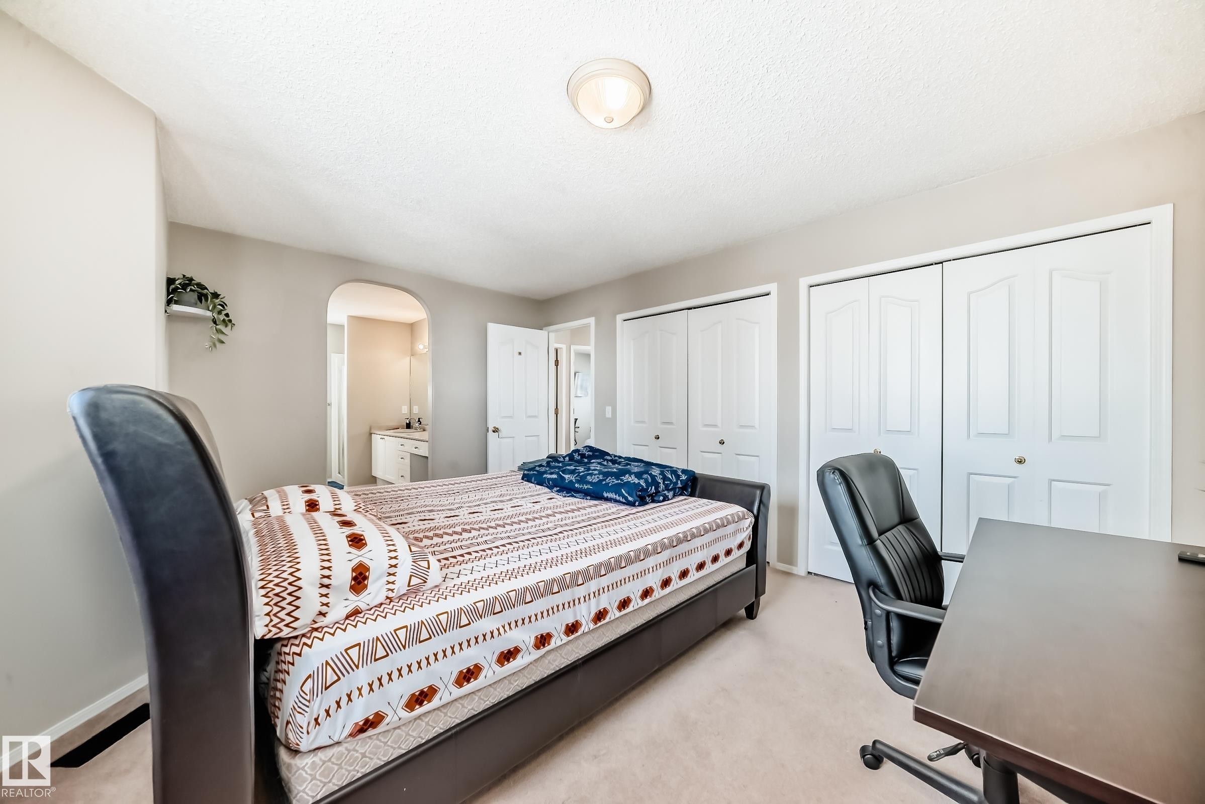 This room features carpeted flooring, a light-colored ceiling, and white walls, creating a bright and airy atmosphere - 19024 50 Avenue, Edmonton, AB - Indoor Photo Showing Bedroom