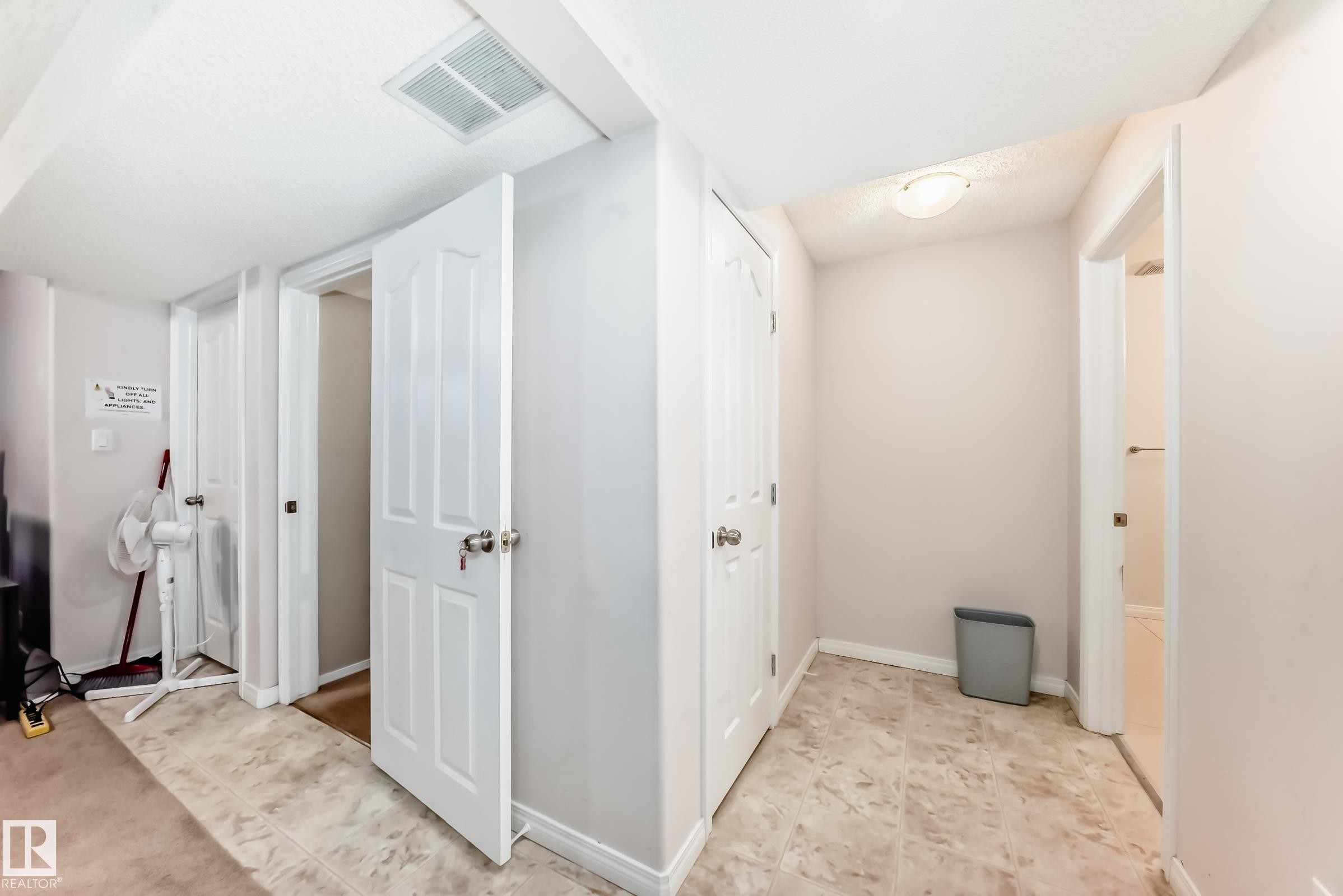 Hallway featuring neutral-toned walls, tile flooring, and white interior doors - 19024 50 Avenue, Edmonton, AB - Indoor Photo Showing Other Room