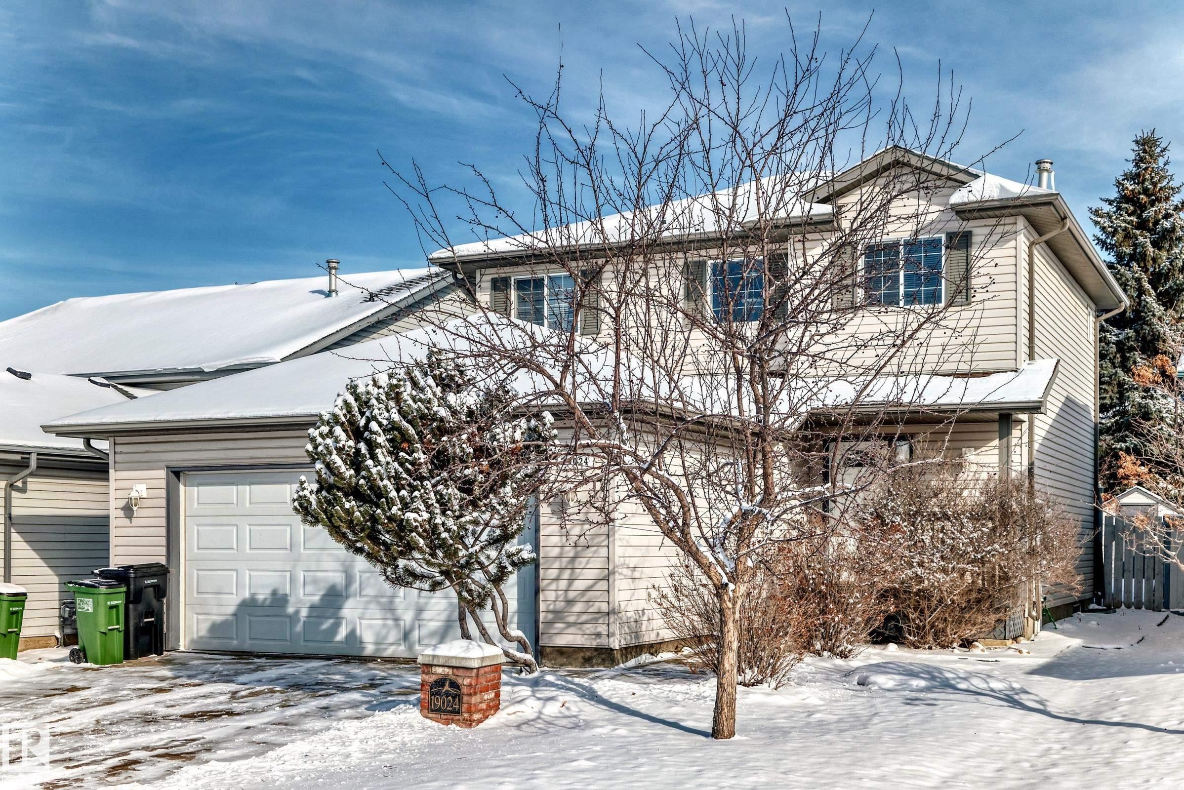 The property features light-colored siding, a pitched roof, and a single-car garage - 19024 50 Avenue, Edmonton, AB - Outdoor