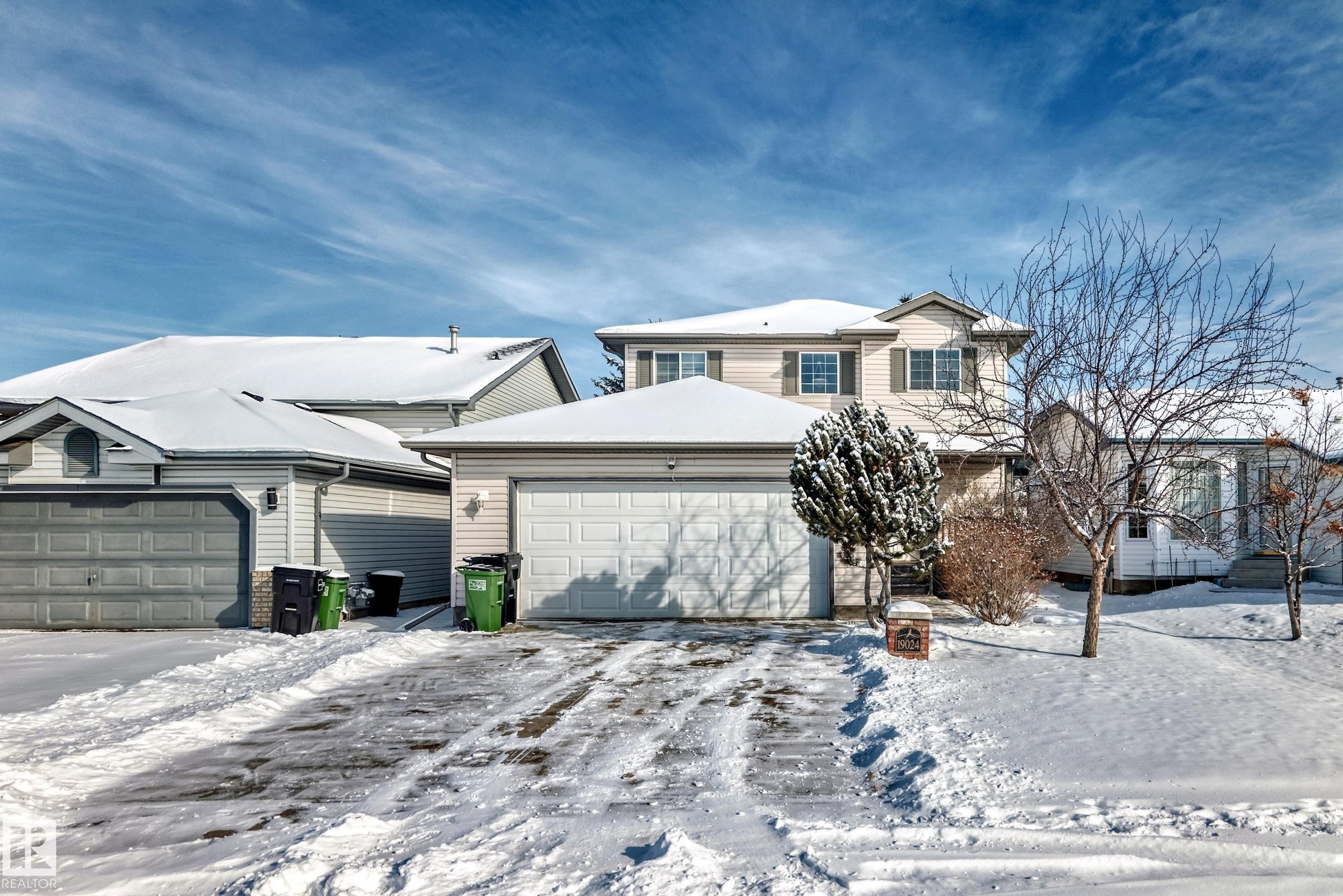The property features a two-story design with a two-car garage and a paved driveway - 19024 50 Avenue, Edmonton, AB - Outdoor With Facade