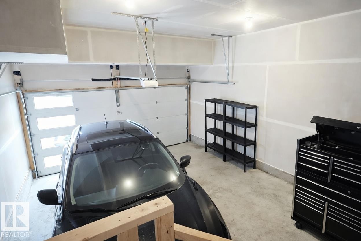 This photo has been digitally enhanced. - 15 Gambel Loop, Spruce Grove, AB - Indoor Photo Showing Garage