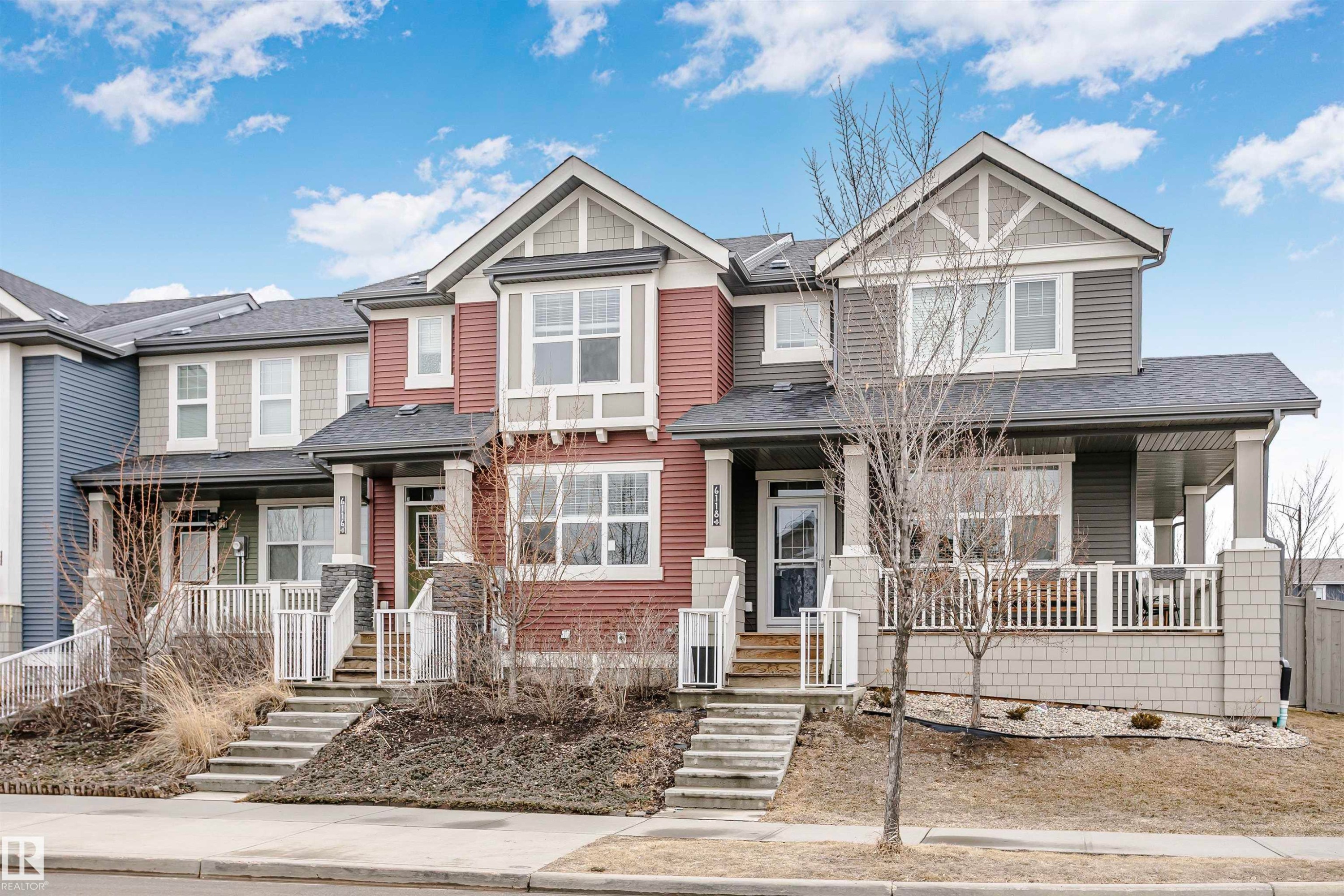 This property features a multi-level facade with varied siding and stone accents - 6116 Rosenthal Way, Edmonton, AB - Outdoor With Deck Patio Veranda With Facade