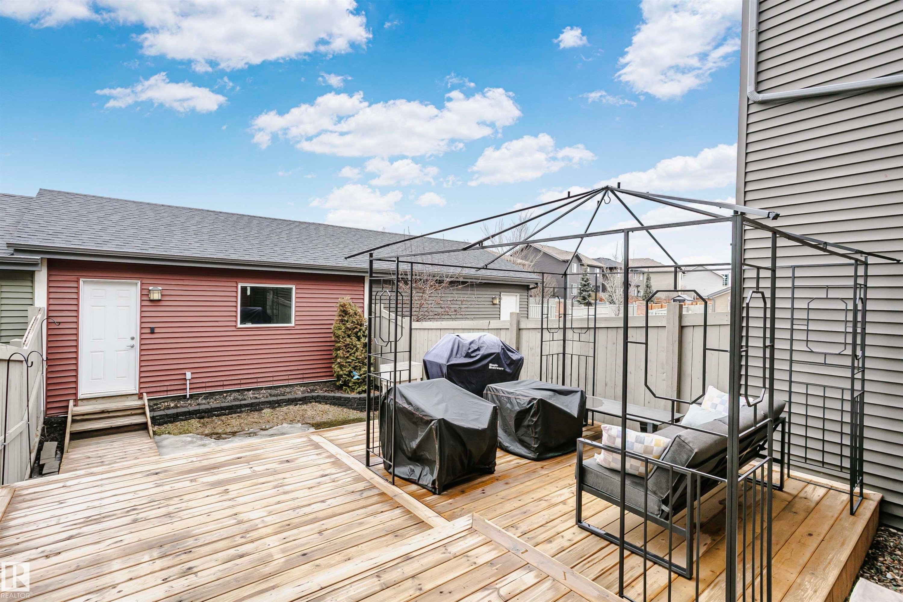 The property features a spacious wooden deck, ideal for outdoor living - 6116 Rosenthal Way, Edmonton, AB - Outdoor With Deck Patio Veranda With Exterior