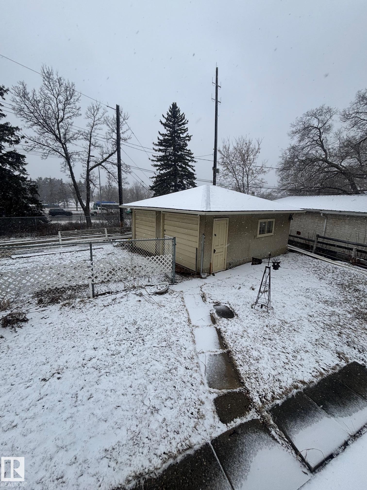 The property features a detached exterior structure with a pitched roof and a window - 11255 71 Avenue, Edmonton, AB - Outdoor