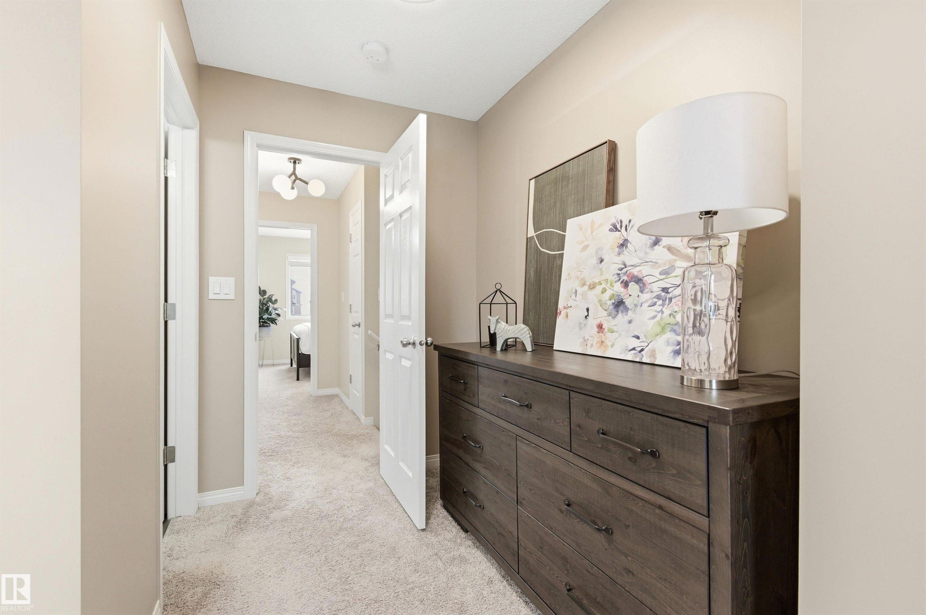Hallway with light-colored carpet flooring and neutral wall tones - 3247 Cherry Crescent, Edmonton, AB - Indoor Photo Showing Other Room