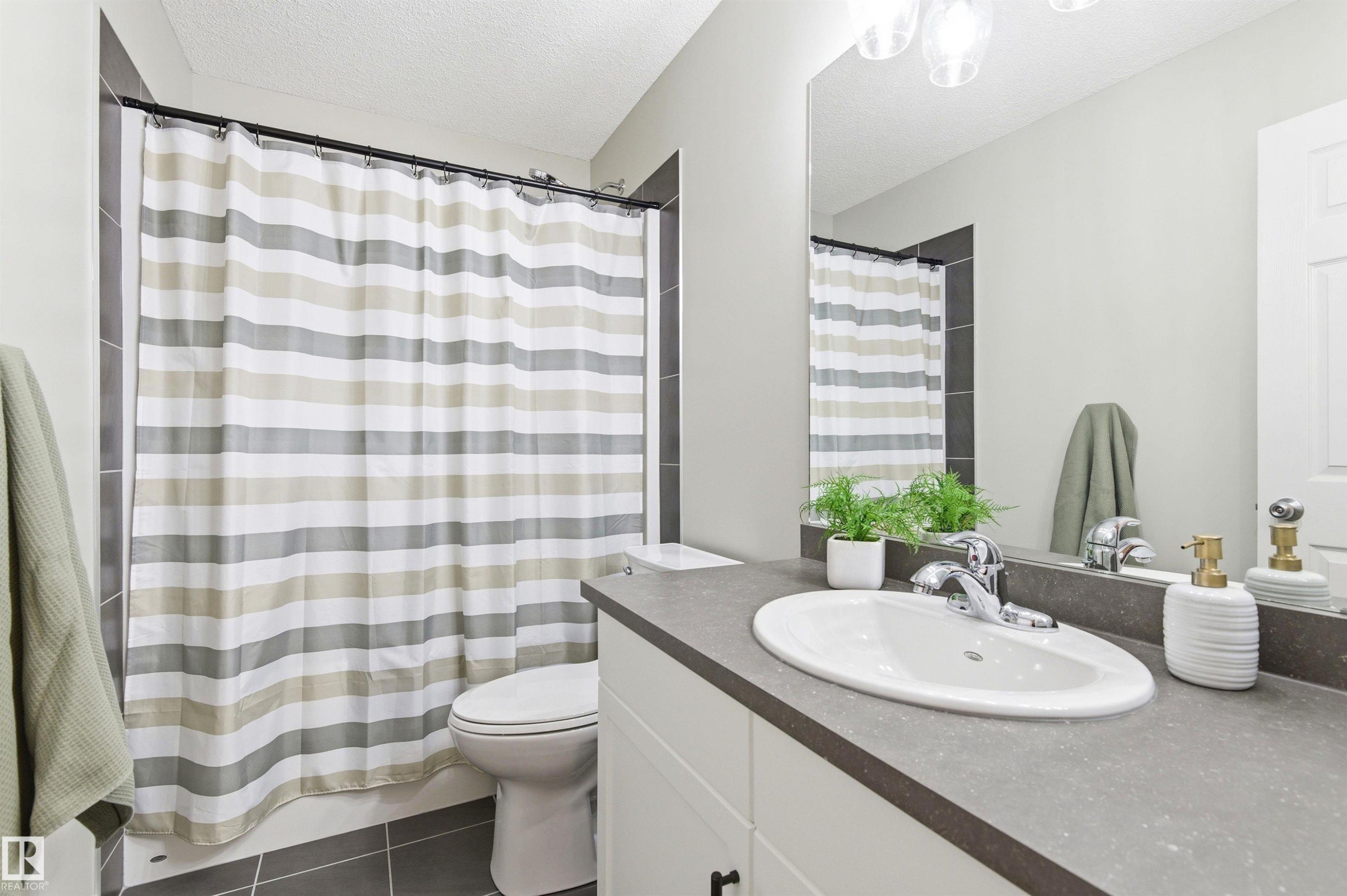 Bathroom featuring a vanity with an integrated sink and a large mirror - 3247 Cherry Crescent, Edmonton, AB - Indoor Photo Showing Bathroom