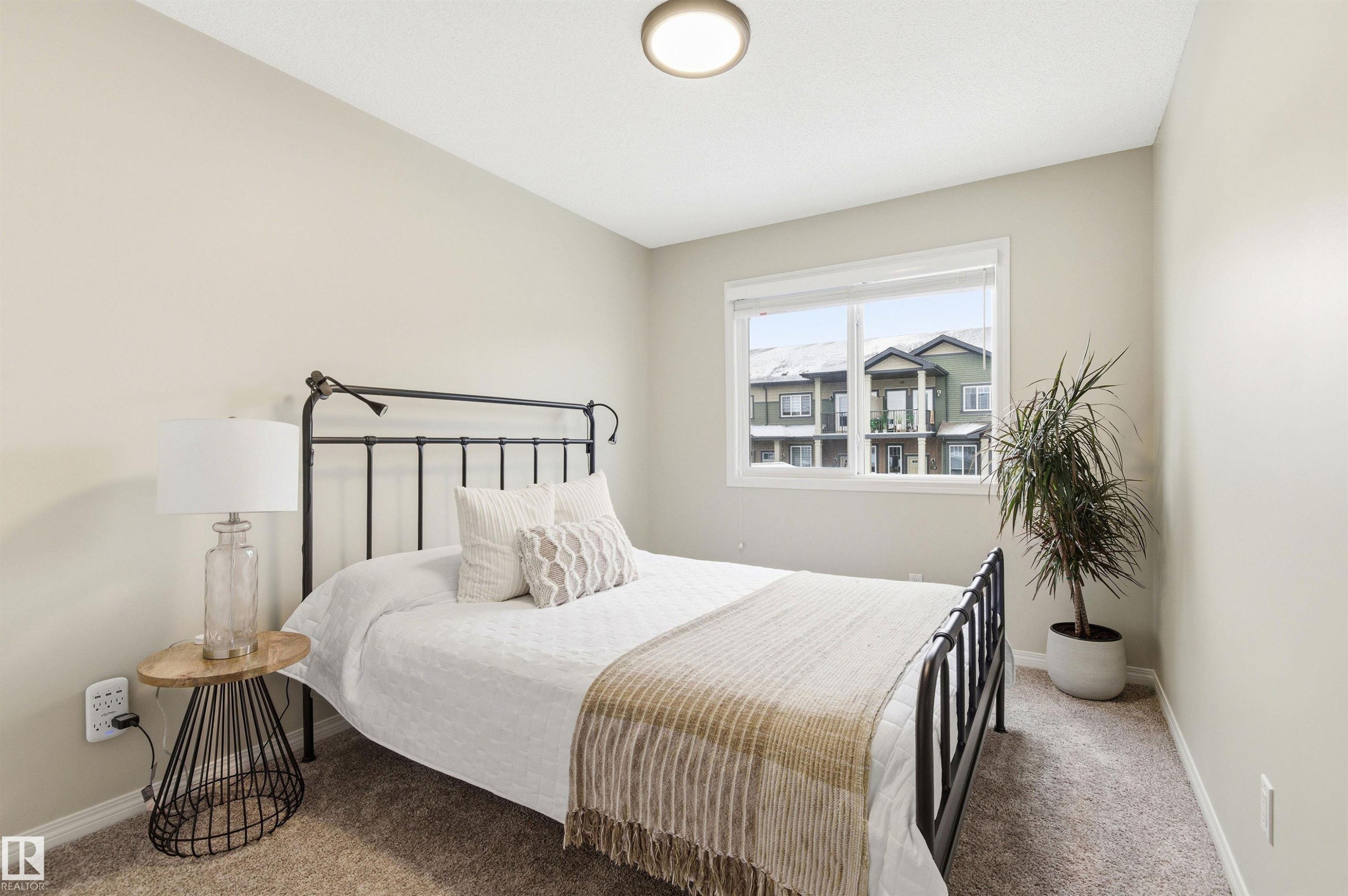 This room features a window providing natural light, neutral-toned walls, and carpeting - 3247 Cherry Crescent, Edmonton, AB - Indoor Photo Showing Bedroom