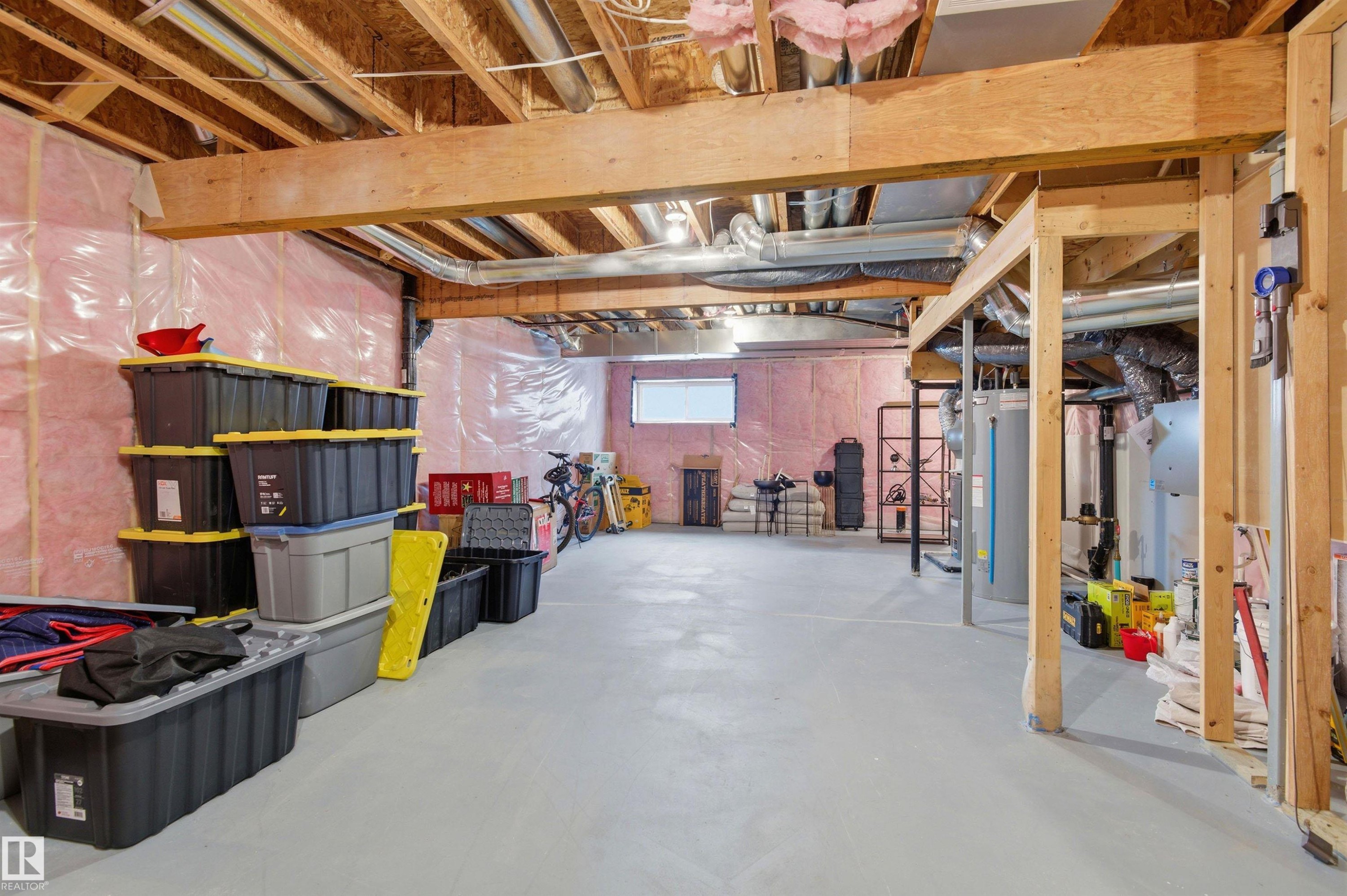 The property features an unfinished basement with exposed wooden beams, insulation, and a concrete floor - 3247 Cherry Crescent, Edmonton, AB - Indoor Photo Showing Basement