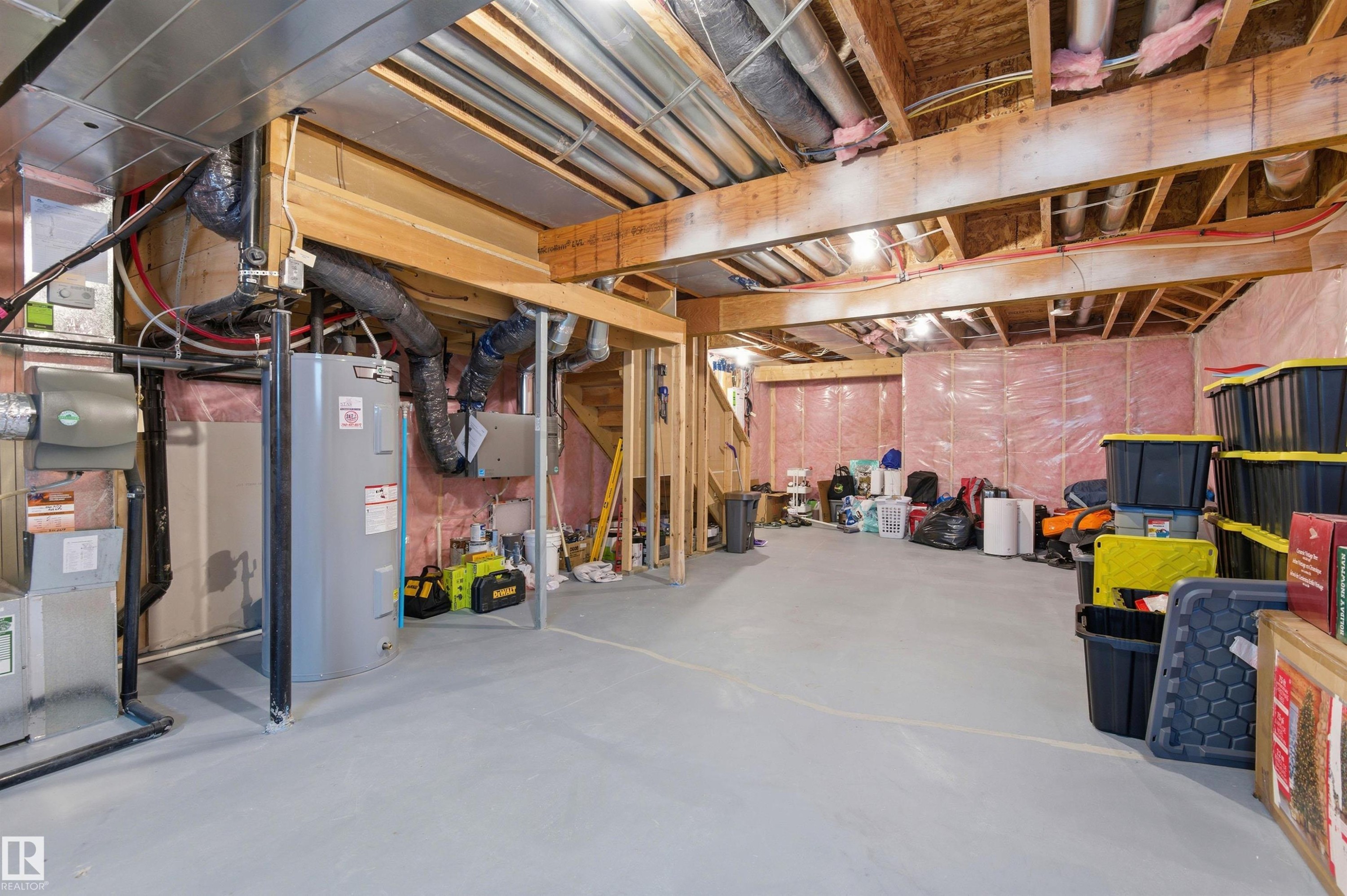 The property includes an unfinished basement with exposed wooden beams, insulation, and a water heater - 3247 Cherry Crescent, Edmonton, AB - Indoor Photo Showing Basement
