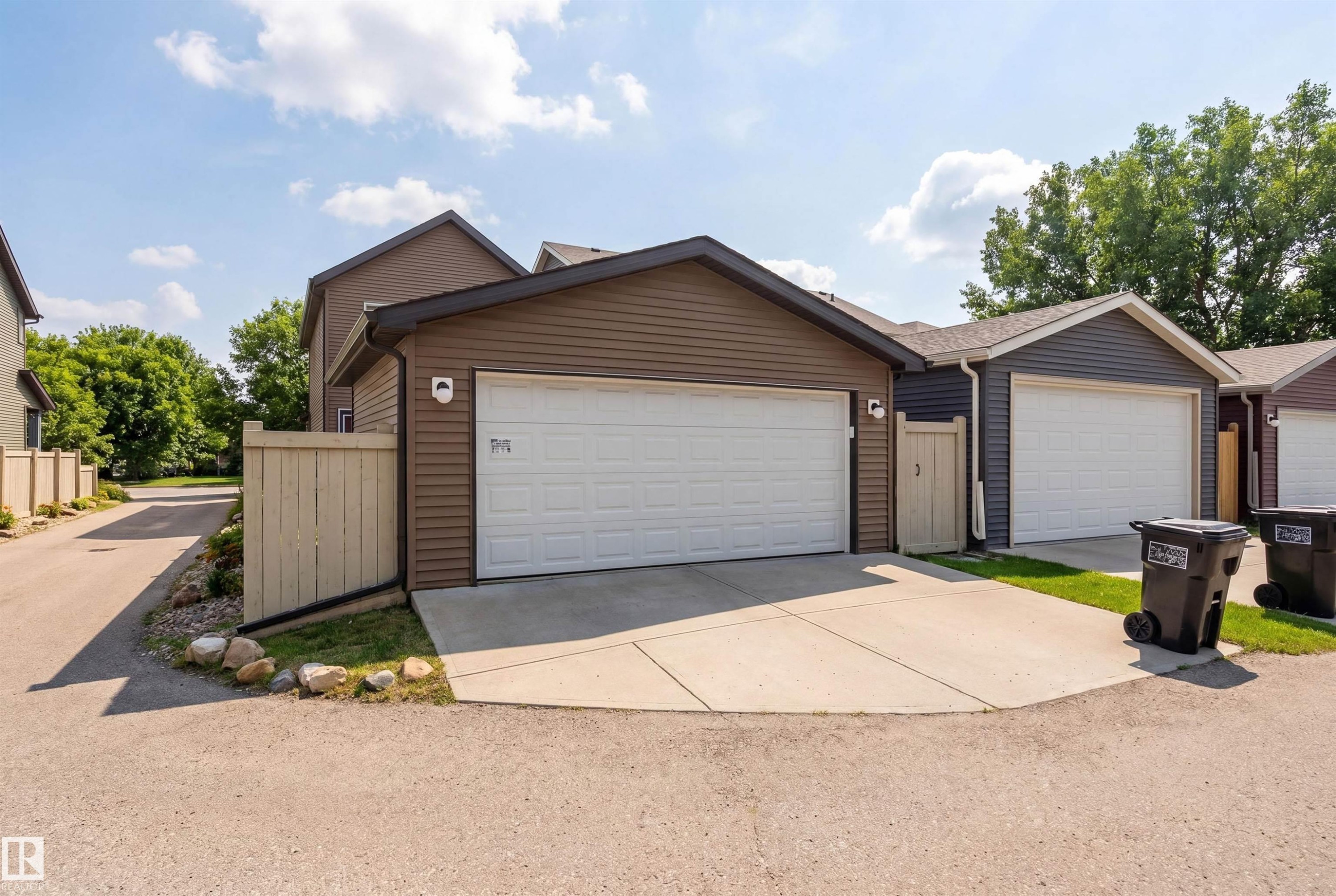 The property features a garage with a white door and brown siding - 3247 Cherry Crescent, Edmonton, AB - Outdoor With Exterior