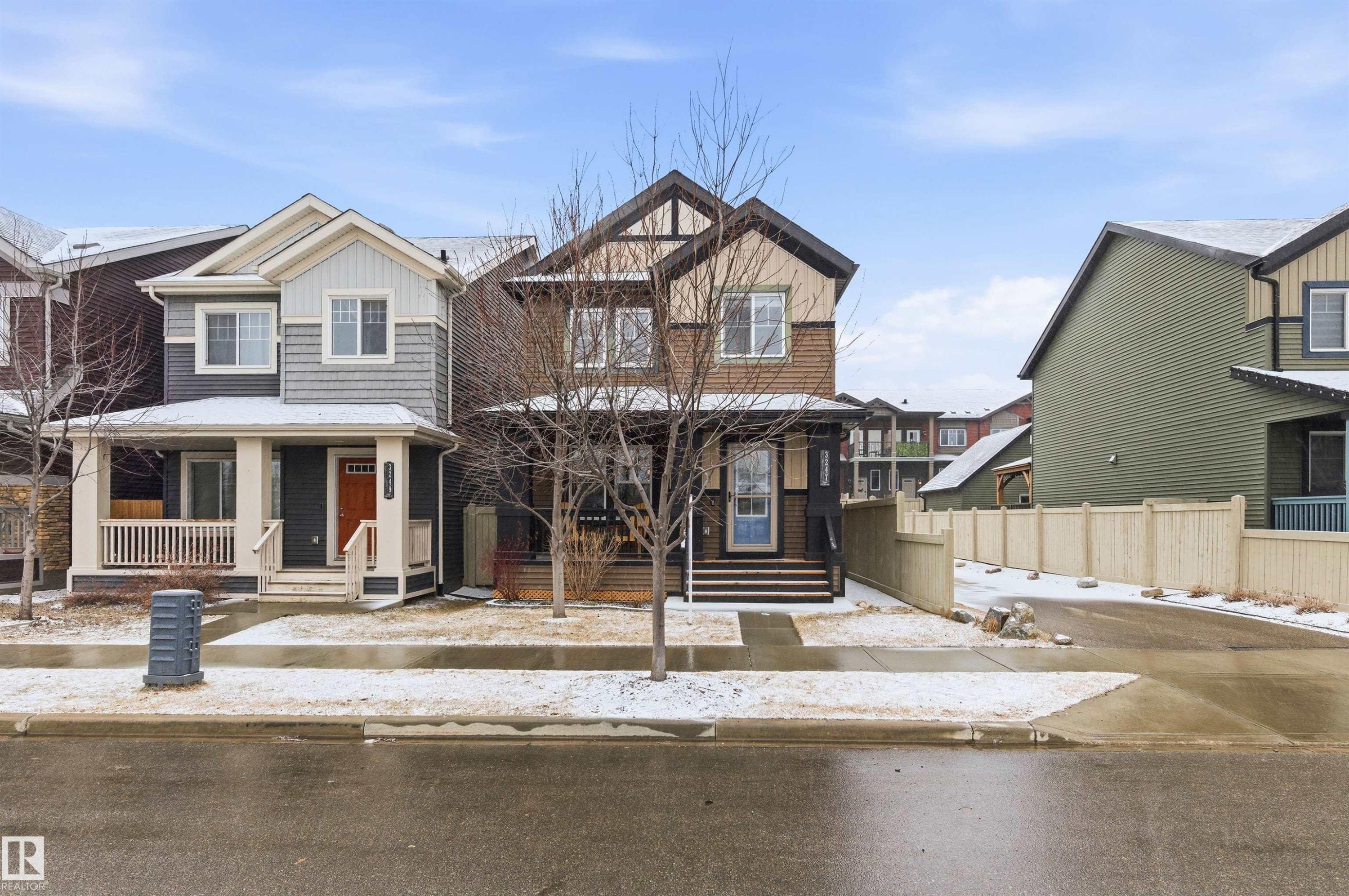 This property features a two-story exterior with a covered front porch, dark siding, and light-colored trim - 3247 Cherry Crescent, Edmonton, AB - Outdoor With Facade