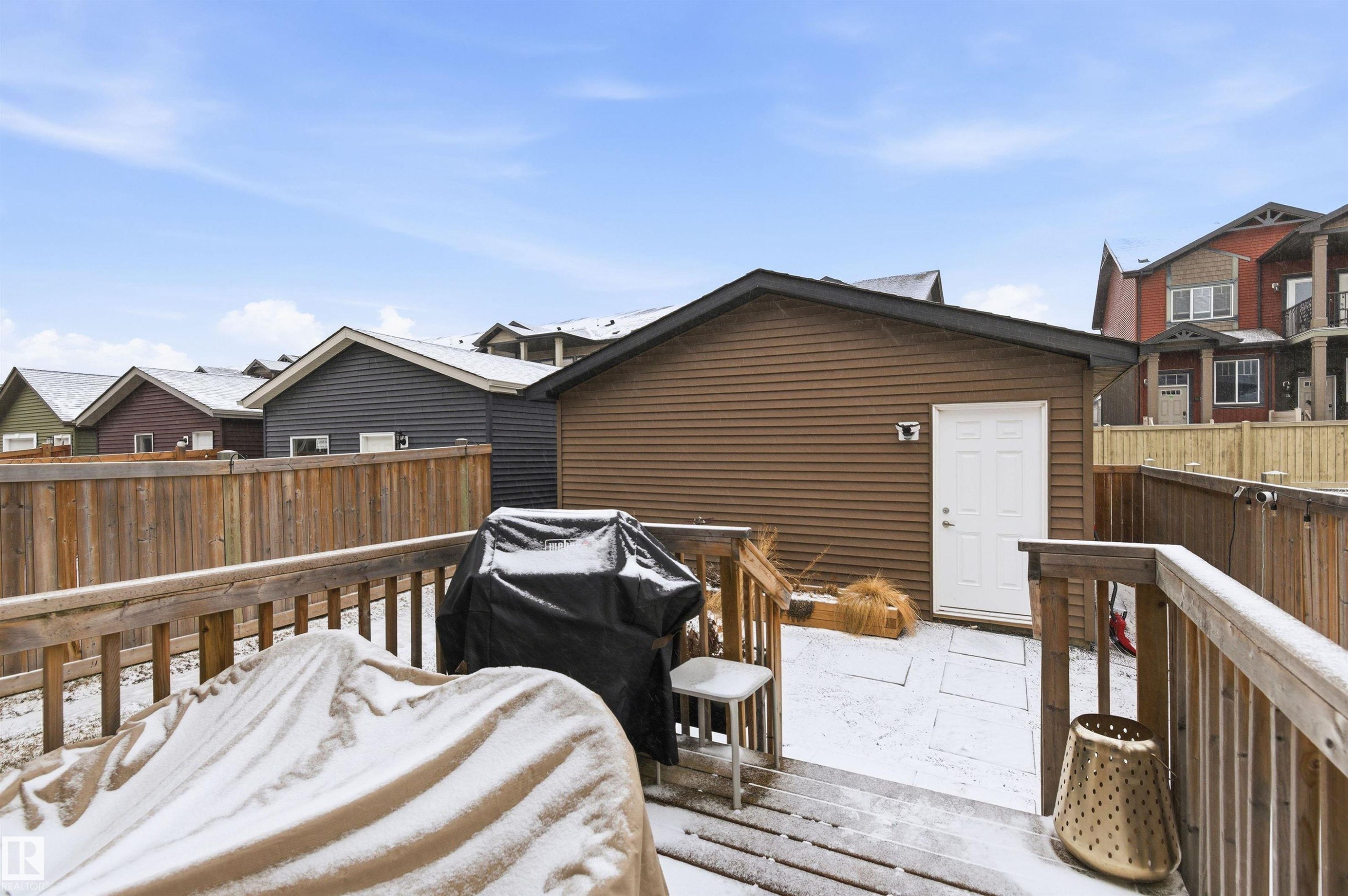 The property features a wooden deck with railing, providing outdoor space - 3247 Cherry Crescent, Edmonton, AB - Outdoor