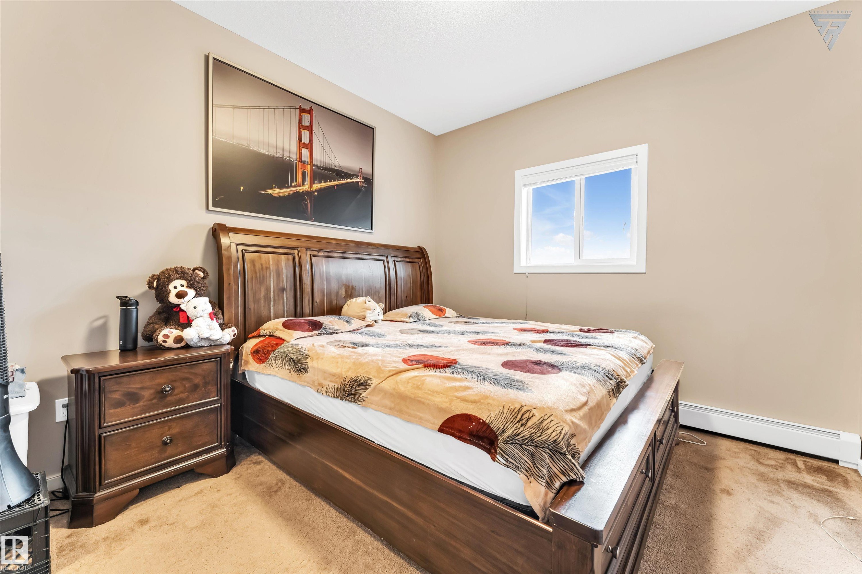 This room features neutral-toned walls, a window providing natural light, and carpeted flooring - #418 392 Silver Berry Road Nw, Edmonton, AB - Indoor Photo Showing Bedroom