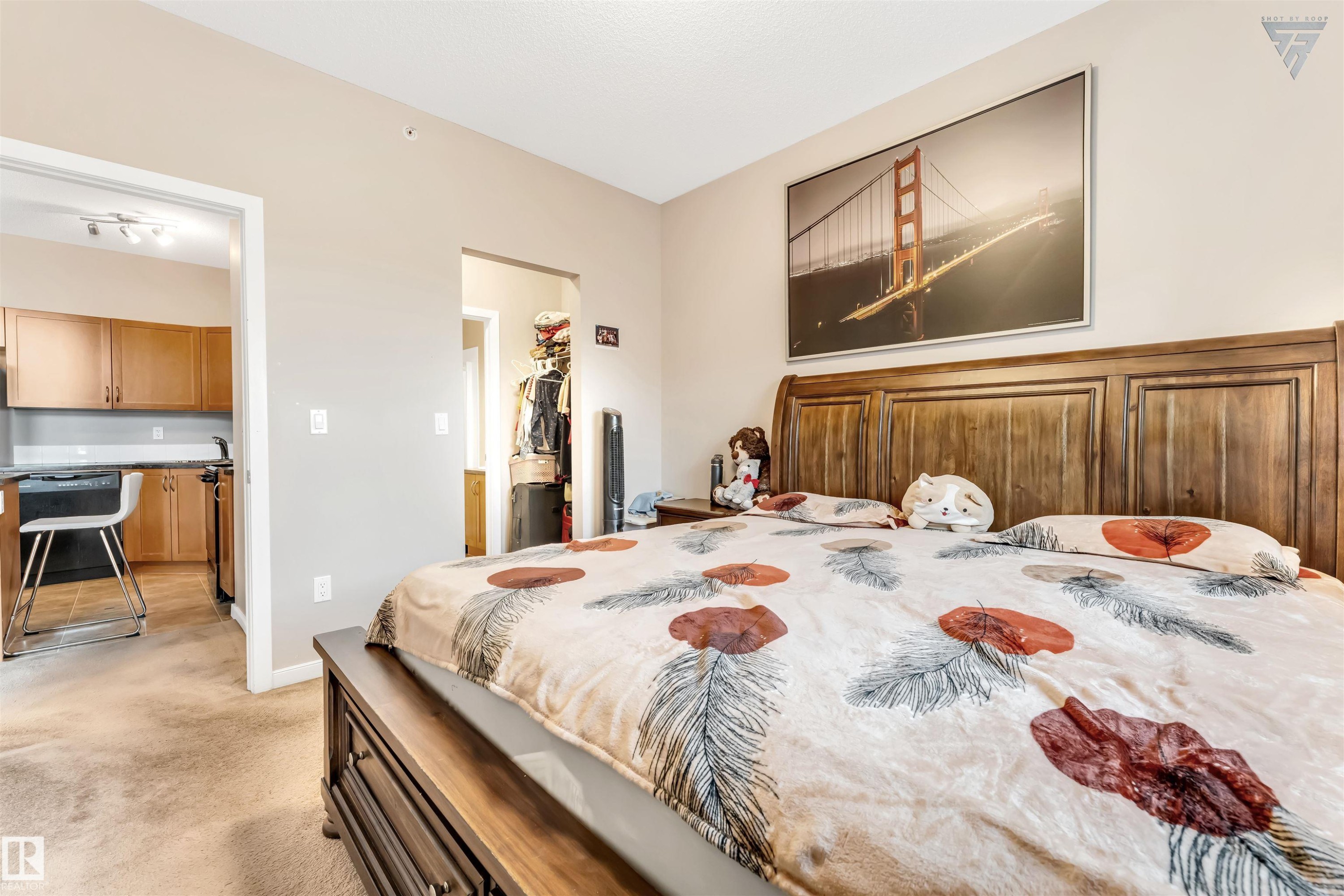 This room features a hardwood bed frame and a carpeted floor - #418 392 Silver Berry Road Nw, Edmonton, AB - Indoor Photo Showing Bedroom