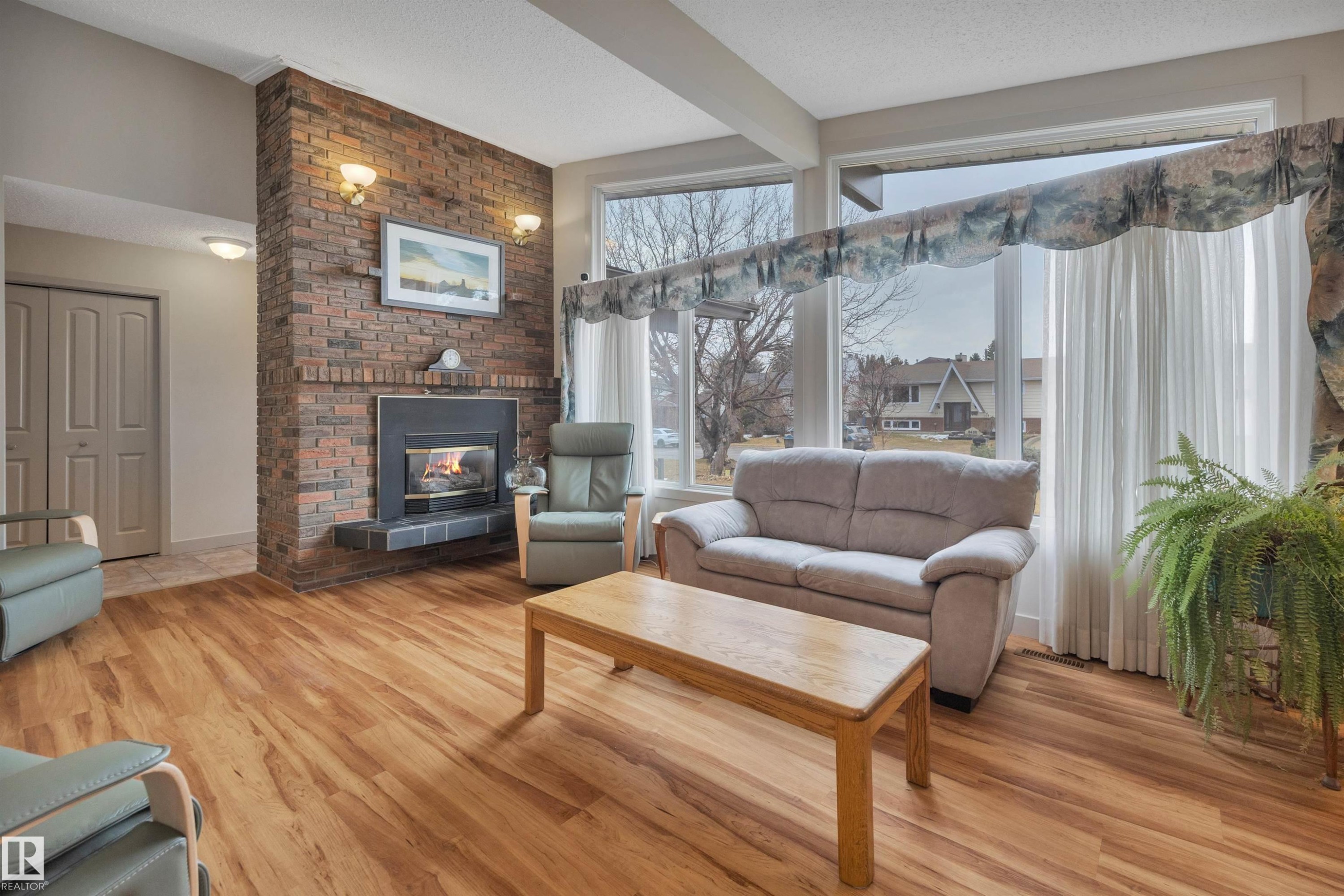 8649 27 Avenue, Edmonton, AB - Indoor Photo Showing Living Room With Fireplace