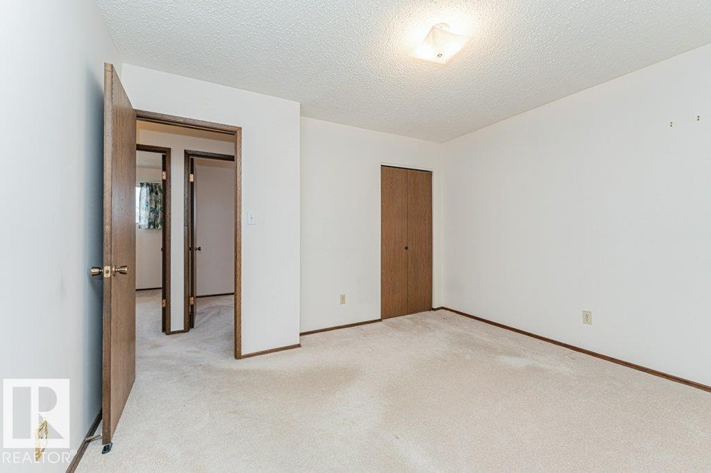 This room features light-colored carpeting, white walls, and a ceiling light fixture - 8804 19 Avenue, Edmonton, AB - Indoor Photo Showing Other Room